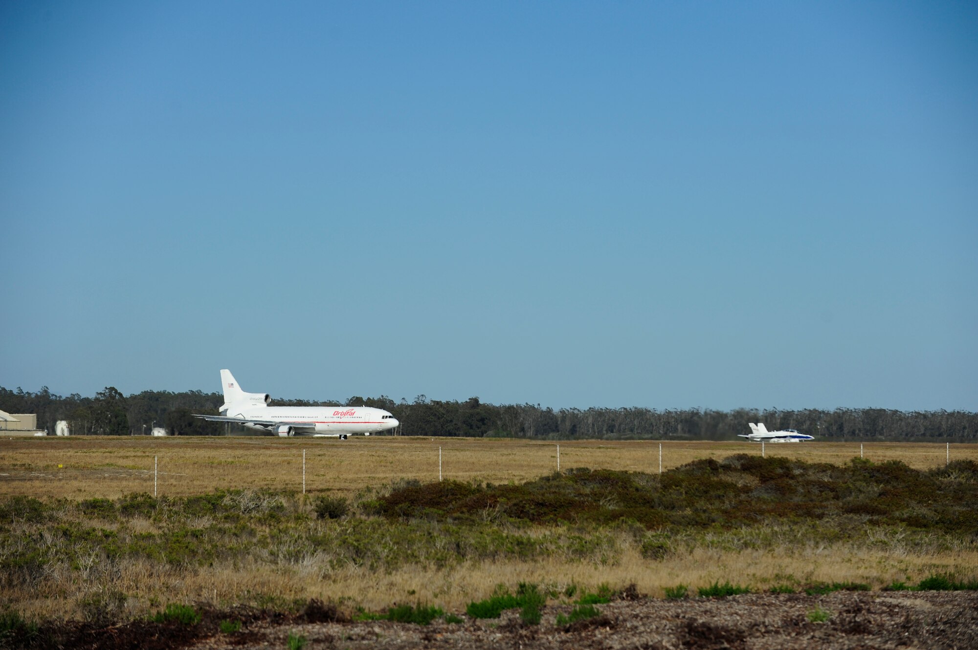 VANDENBERG AIR FORCE BASE, Calif. – A L-1011 “Stargazer” carrier aircraft and its lead plane prepare for take-off at the base flightline here Thursday, June 27, 2013. The launch of an Orbital Sciences Corporation Pegasus XL rocket launched from the “Stargazer” carrier aircraft off the coast of Monterey Bay.  (U.S. Air Force photo/Senior Airman Lael Huss)