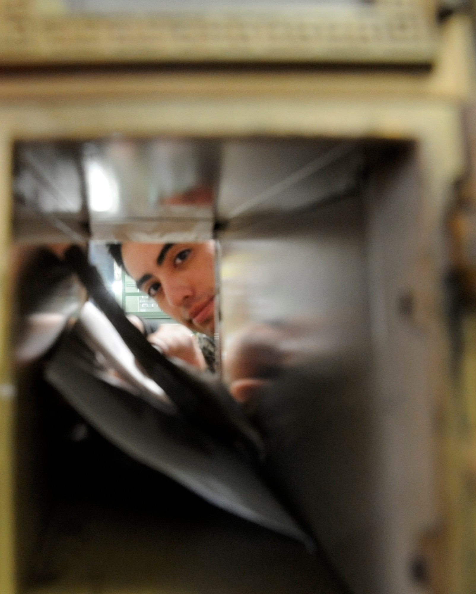 U.S. Air Force Airman 1st Class Julian Bran, 35th Communications Squadron postal clerk, places mail into a mail box at Misawa Air Base, Japan, June 27, 2013. The post office processes approximately 56,000 pieces of mail per week. (U.S. Air Force photo by Airman 1st Class Kenna Jackson)