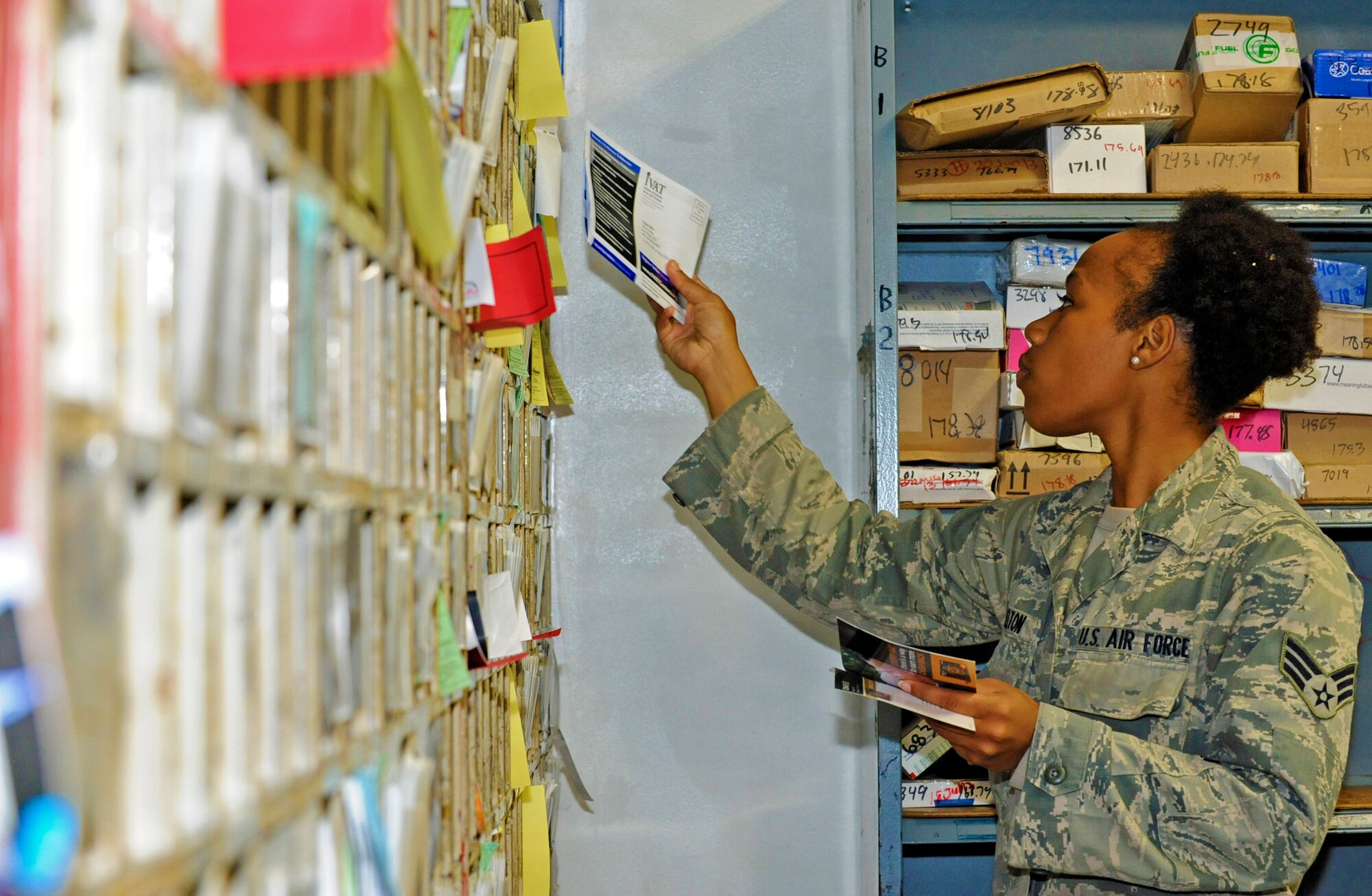U.S. Air Force Senior Airman Danielle Melton, 35th Communications Squadron postal clerk, puts mail into mail boxes at Misawa Air Base, Japan, June 27, 2013. The post office distributes around 4,000 pieces of mail daily to approximately 6,000 P.O. boxes. (U.S. Air Force photo by Airman 1st Class Kenna Jackson)