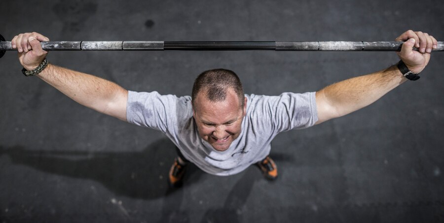 Rick Myhre, 366th Aerospace Medicine Squadron Heath and Wellness Center physiologist, performs an overhead squat in the Fitness Center at Mountain Home Air Force Base, Idaho, June 26, 2013. Myhre helps Airmen become more physically fit through exercise. (U.S. Air Force photo/Tech. Sgt. Samuel Morse)