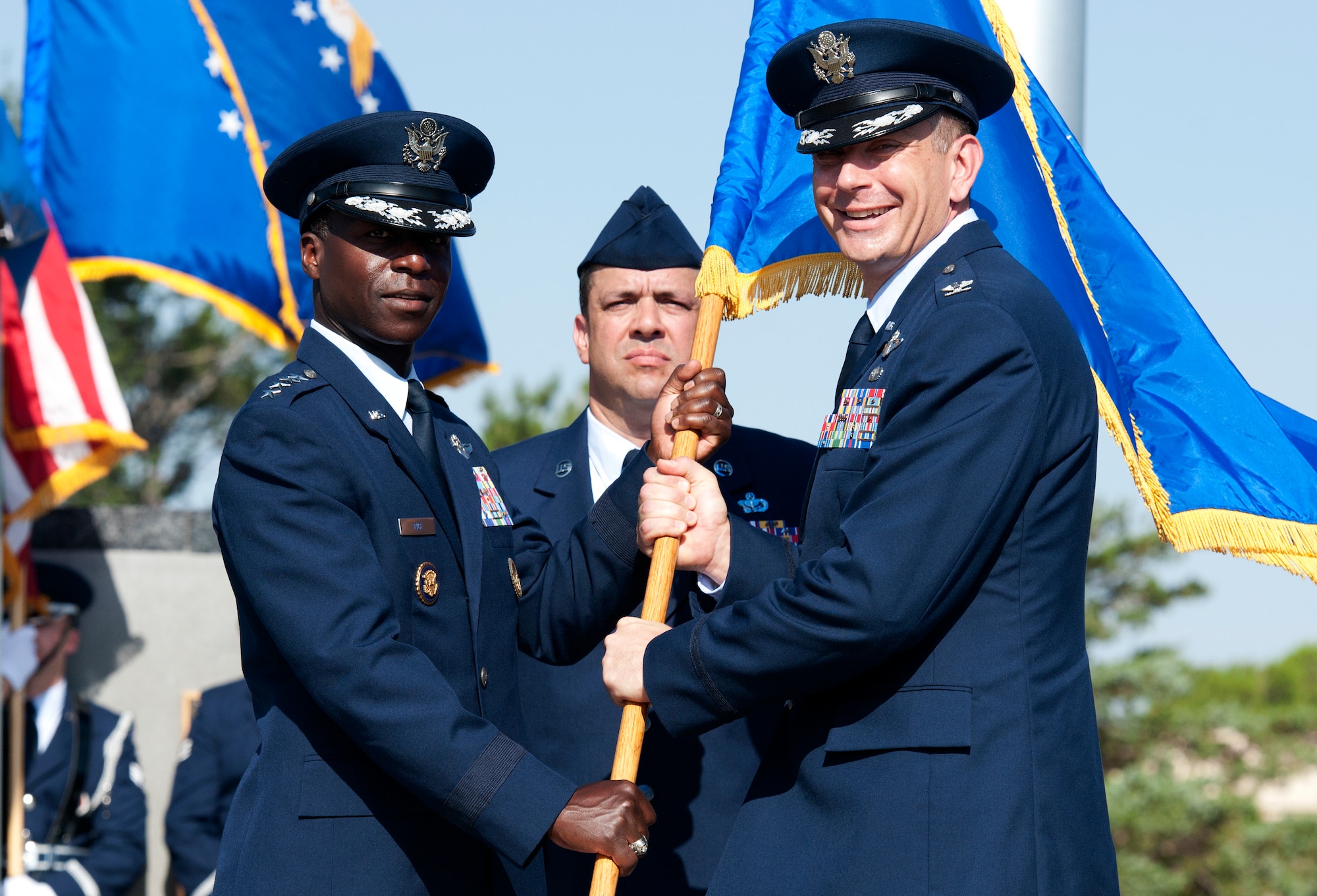 ALTUS AIR FORCE BASE, Okla. – Gen. Edward A. Rice Jr., commander of Air Education and Training Command, gives the 97th Air Mobility Wing flag to Col. William A. Spangenthal, incoming 97th AMW commander, as part of the 97th AMW change of command ceremony, June 27. Col. Krawietz relinquished command to Col. William A. Spangenthal, incoming 97th AMW commander, in a centuries-old tradition that allows the passing of responsibility from one commander to the next. (U.S. Air Force photo by Senior Airman Jesse Lopez / Released)