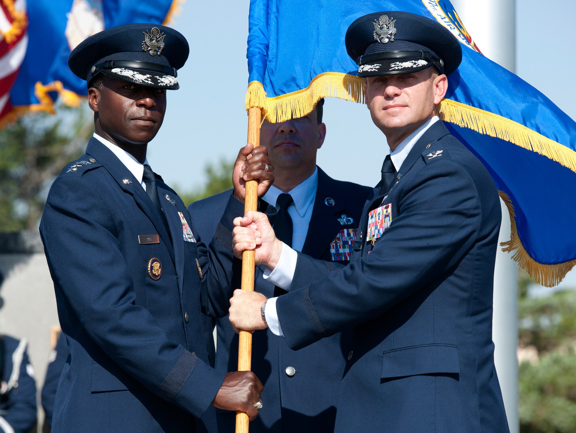 ALTUS AIR FORCE BASE, Okla. – Gen. Edward A. Rice Jr., commander of Air Education and Training Command, retrieves the 97th Air Mobility Wing flag from Col. Anthony B. Krawietz, 97th AMW commander, as part of the 97th AMW change of command ceremony, held at Wings of Freedom Park, June 27. Col. Krawietz relinquished command to Col. William A. Spangenthal, incoming 97th AMW commander, in a centuries-old tradition that allows the passing of responsibility from one commander to the next. (U.S. Air Force photo by Senior Airman Jesse Lopez / Released)