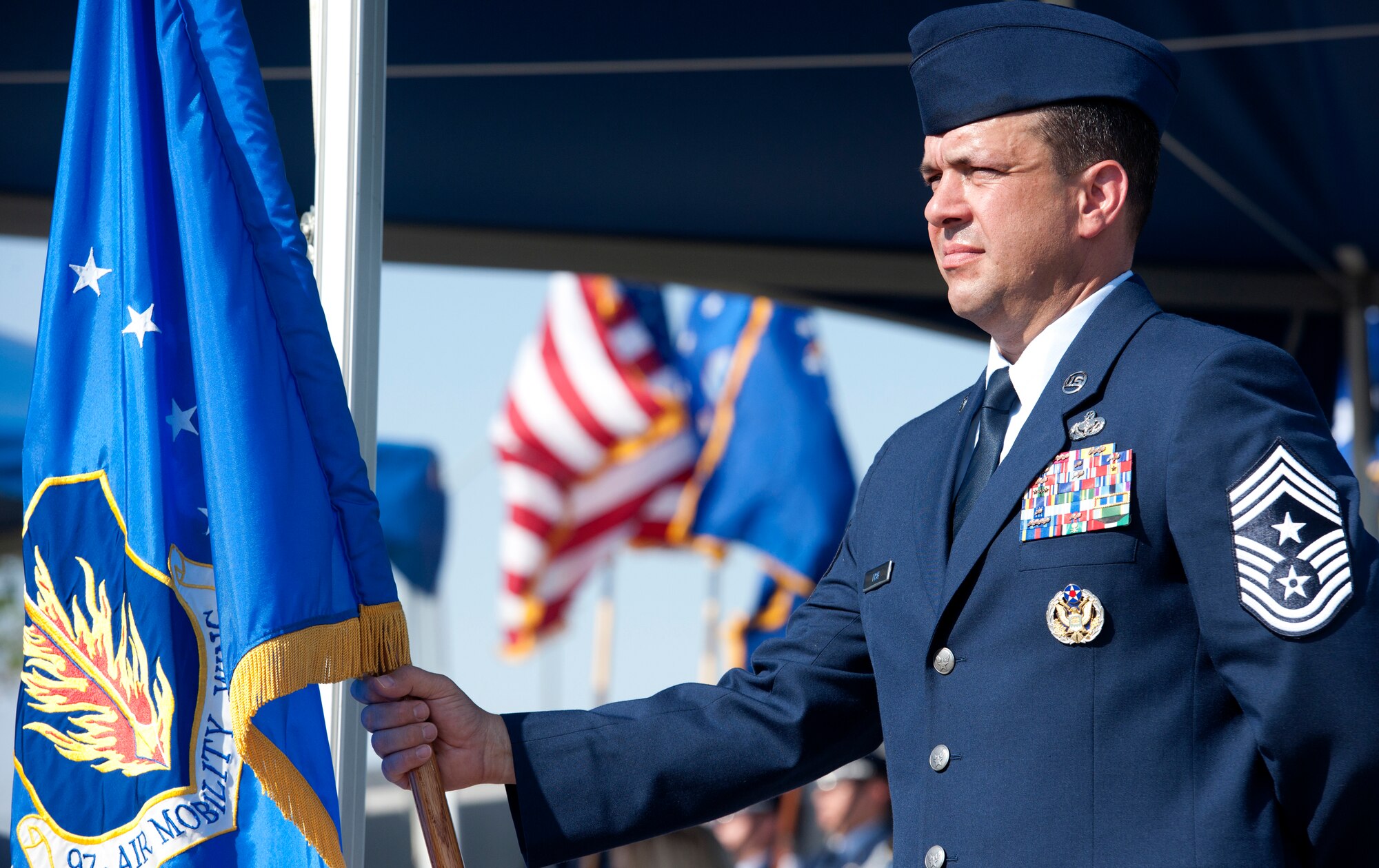 ALTUS AIR FORCE BASE, Okla. – Command Chief Master Sgt. David Fish, 97th Air Mobility Wing command chief, holds the wing guidon as part of the 97th AMW change of command ceremony, held at Wings of Freedom Park, June 27. The 97th AMW observed a change of command in which the flag of responsibility and leadership passed from Col. Anthony B. Krawietz, 97th AMW commander, to Col. William A. Spangenthal, incoming 97th AMW commander. (U.S. Air Force photo by Senior Airman Jesse Lopez / Released)