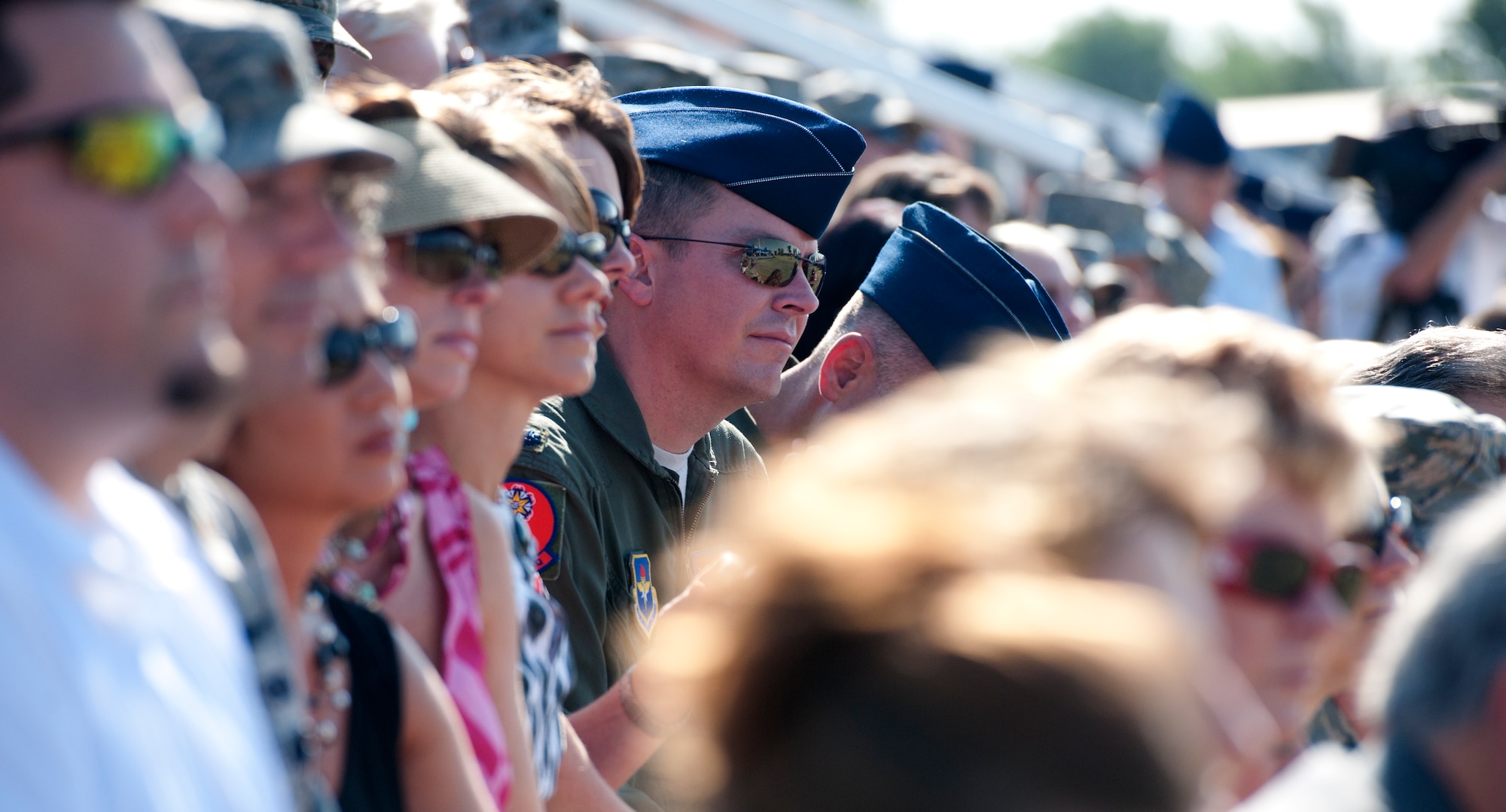 ALTUS AIR FORCE BASE, Okla. – Members of the 97th Air Mobility Wing look on as the 97th AMW change of command ceremony takes place at Wings of Freedom Park, June 27. In a centuries-old tradition, Col. William A. Spangenthal assumed command from Col. Anthony B. Krawietz. The change of command is a formal transfer of responsibility from one commander to the next. This ceremony is performed before wing members, allowing each person to observe the placing of authority and responsibility. (U.S. Air Force photo by Senior Airman Jesse Lopez / Released)