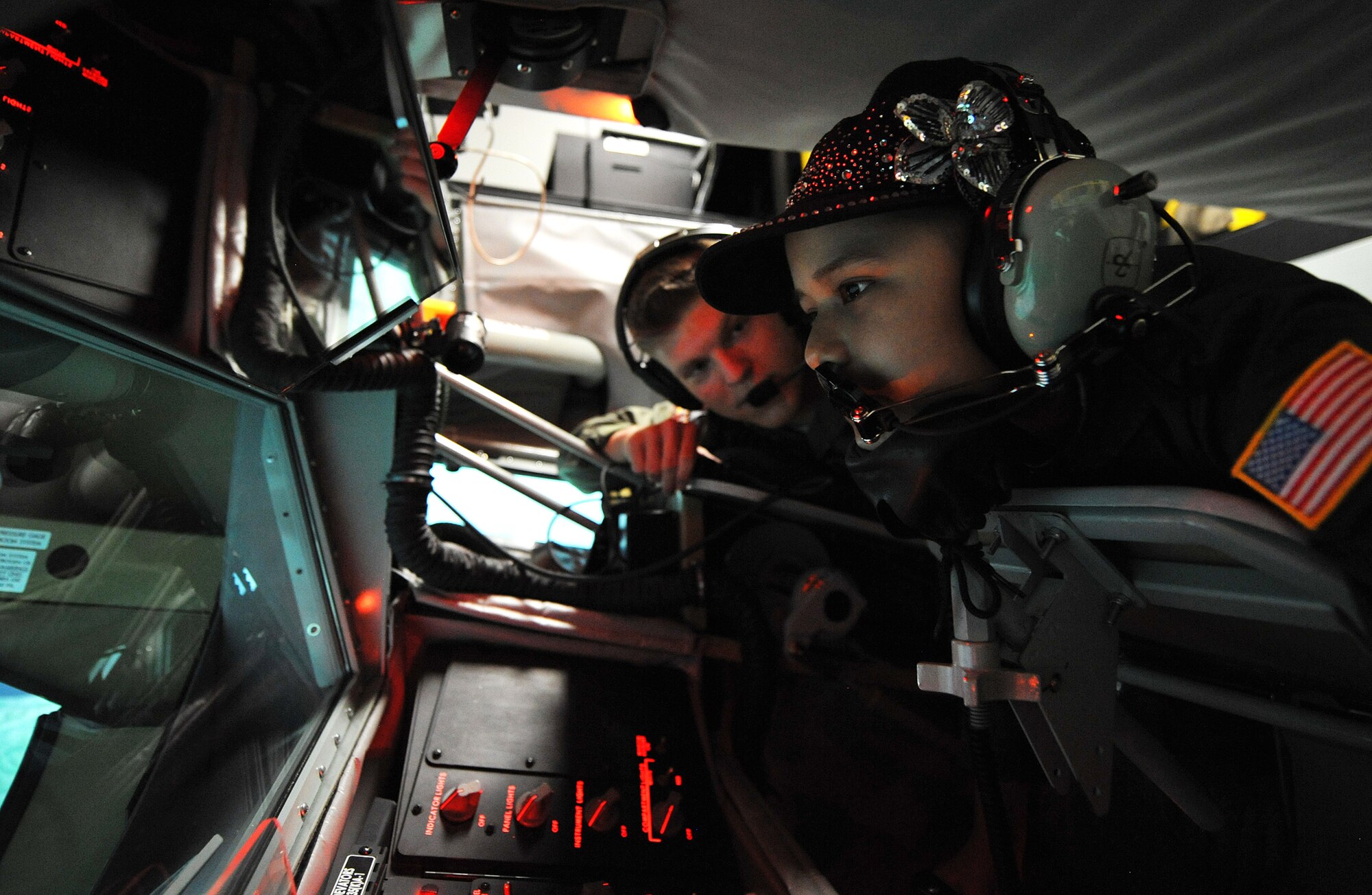 Senior Airman Kyle Engasser, 384th ARS boom operator, helps Esmeralda Quinonez-Jauregui, 11-year-old Leukemia survivor and honorary ‘Pilot for a Day,’ simulate in-flight refueling in an use a KC-135 Stratotanker Boom Operator Weapon System Trainer, June 27, 2013, at McConnell Air Force Base, Kan. Esmeralda and her family toured the base with members of the 384th ARS as part of the ‘Pilot for a Day’ program, an Air Force program that allows medically-challenged youth a chance to visit bases and become part of the Air Force family. (U.S. Air Force photo/ Staff Sgt. Jess Lockoski)