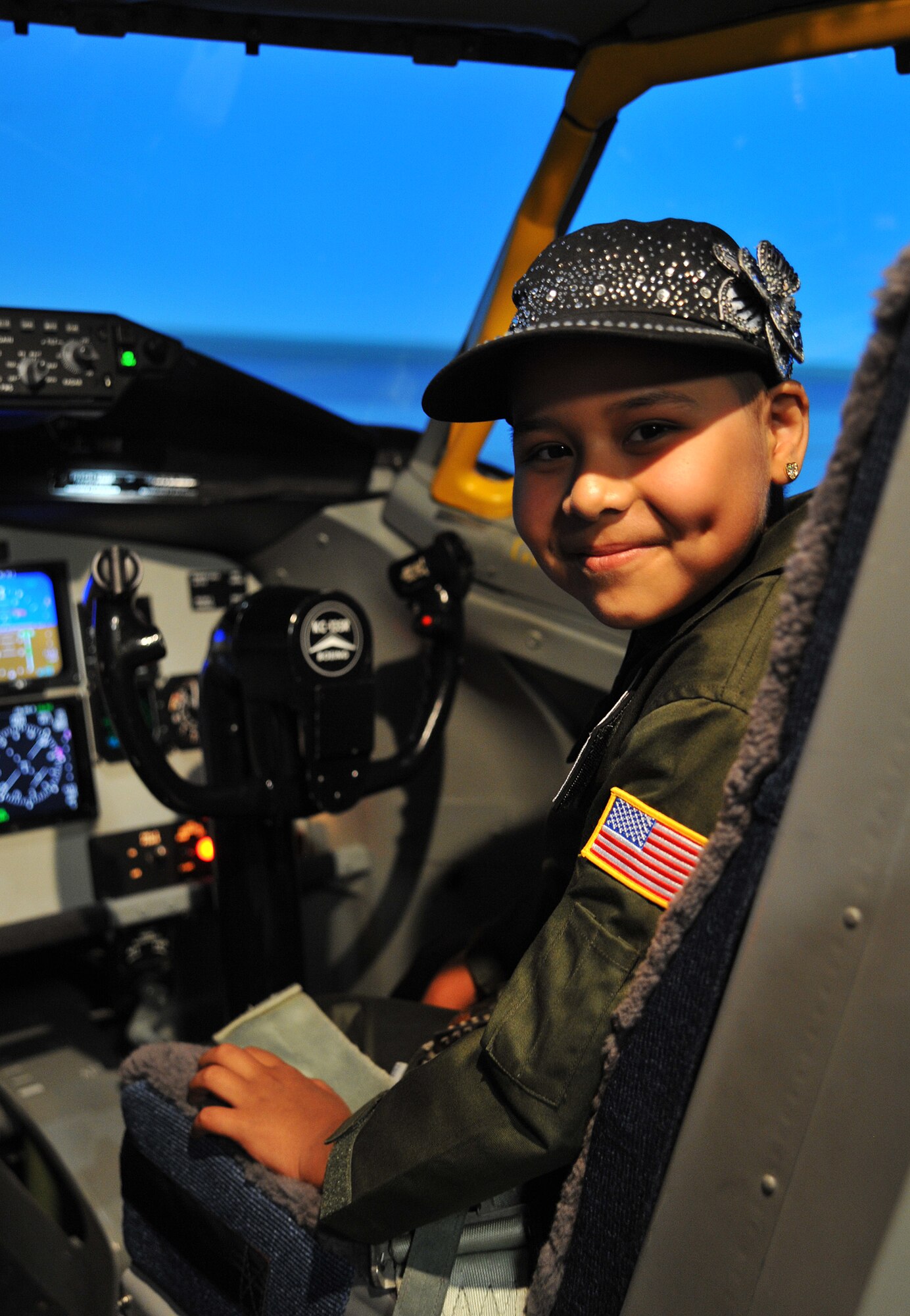 Esmeralda Quinonez-Jauregui, 11-year-old Leukemia survivor, sits in the cockpit of a KC-135 Stratotanker Simulator, June 27, 2013, at McConnell Air Force Base, Kan. Esmeralda and her family toured the base with members of the 384th Air Refueling Squadron as part of the ‘Pilot for a Day’ program, an Air Force program that allows medically-challenged youth a chance to visit bases and become part of the Air Force family. (U.S. Air Force photo/ Staff Sgt. Jess Lockoski)