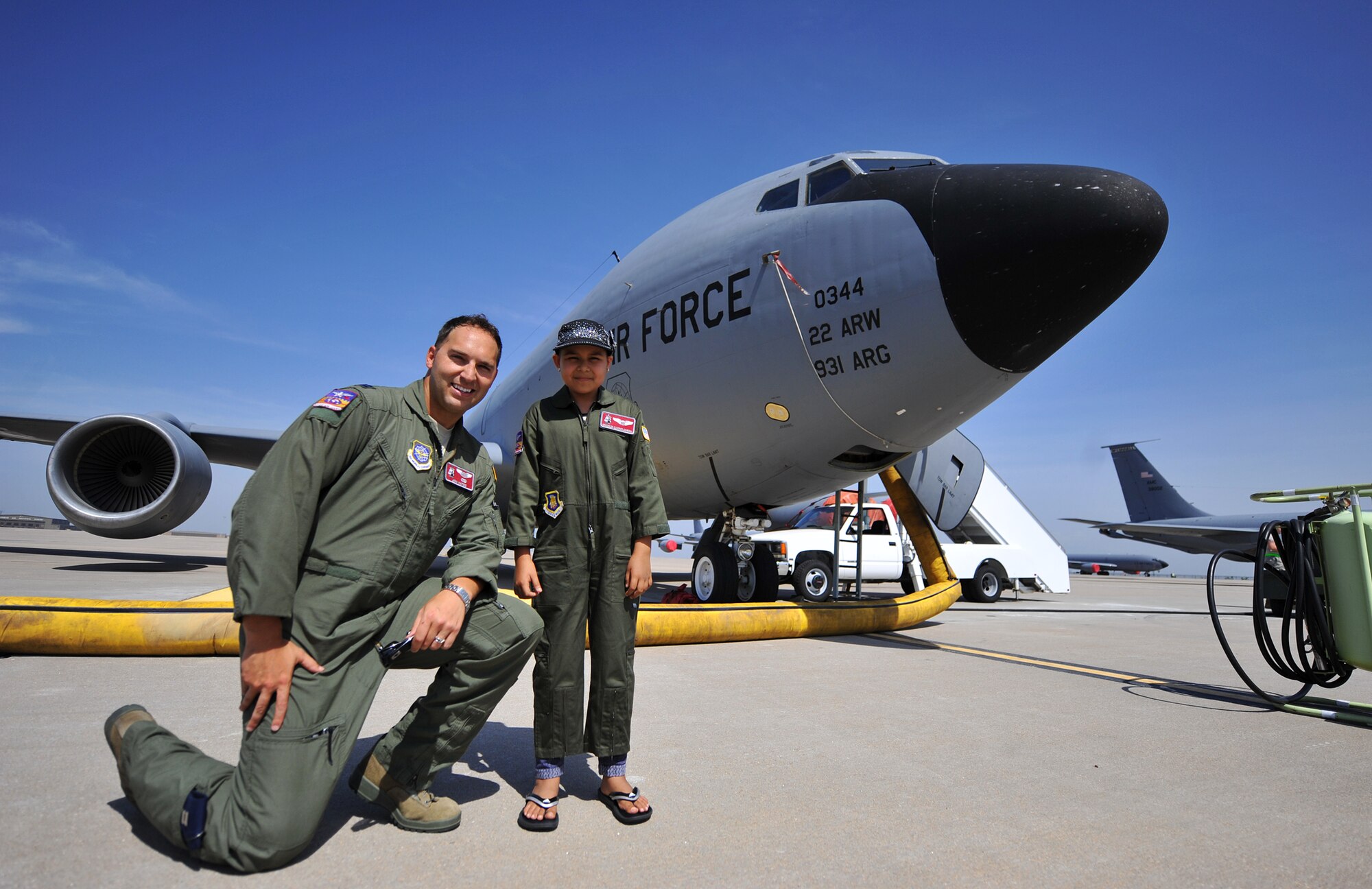 Capt. Jonathan Yates, 384h Air Refueling Squadron pilot, and Esmeralda Quinonez-Jauregui, 11-year-old Leukemia survivor, stand infront of a KC-135 Stratotanker display, June 27, 2013, at McConnell Air Force Base, Kan. Esmeralda and her family toured the base with members of the 384th ARS as part of the ‘Pilot for a Day’ program, an Air Force program that allows medically-challenged youth a chance to visit bases and become part of the Air Force family. (U.S. Air Force photo/ Staff Sgt. Jess Lockoski) 
