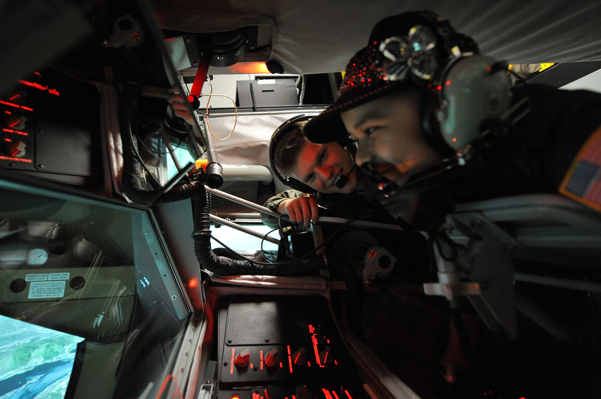 Senior Airman Kyle Engasser, 384th ARS boom operator, helps Esmeralda Quinonez-Jauregui, 11-year-old Leukemia survivor and honorary ‘Pilot for a Day,’ simulate in-flight refueling in an use a KC-135 Stratotanker Boom Operator Weapon System Trainer, June 27, 2013, at McConnell Air Force Base, Kan. Esmeralda and her family toured the base with members of the 384th ARS as part of the ‘Pilot for a Day’ program, an Air Force program that allows medically-challenged youth a chance to visit bases and become part of the Air Force family. (U.S. Air Force photo/ Staff Sgt. Jess Lockoski)
 
