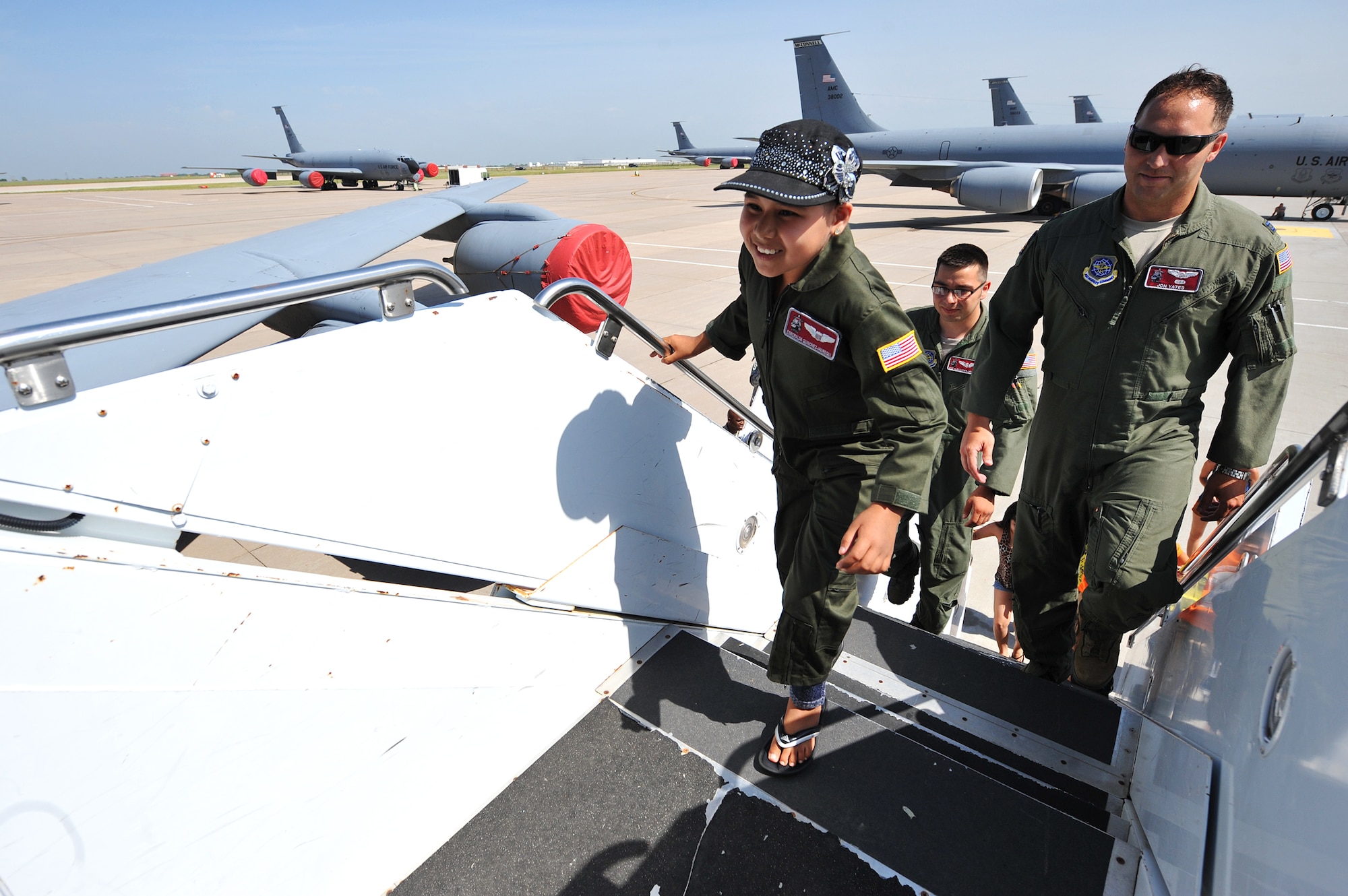 Esmeralda Quinonez-Jauregui, 11-year-old Leukemia survivor, boards a KC-135 Stratotanker display as an honorary pilot and member of the 384th Air Refueling Squadron, with fellow aircrew, June 27, 2013, at McConnell Air Force Base, Kan. Esmeralda was selected for the ‘Pilot for a Day’ program through a partnership with Wesley Medical Center, Wichita, Kan. and joined the McConnell community to see its daily operations.  (U.S. Air Force photo/ Staff Sgt. Jess Lockoski) 