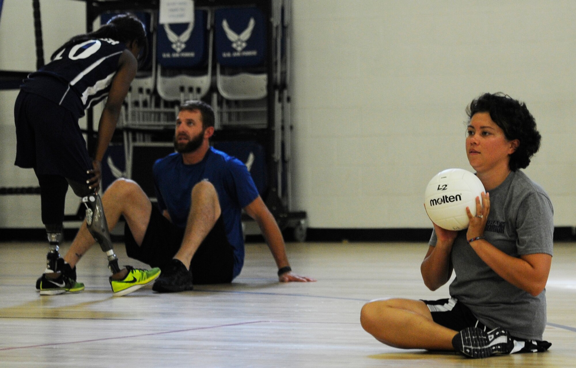 Capt. Sarah Evans, 59th Medical Wing patient learns the fundamentals of sitting volleyball at an Air Force Wounded Warrior Sports Camp Clinic at the Joint Base Andrews West Fitness Center, Md., June 27, 2013.  More than 30 Air Force Wounded Warriors attended the two-day adaptive sports camp of wheelchair basketball, sitting volleyball, archery, swimming, air rifle/pistol shooting and track and field, designed to help them overcome their challenges and enjoy a physically active lifestyle. (U.S. Air Force photo/Airman 1st Class Nesha Humes)