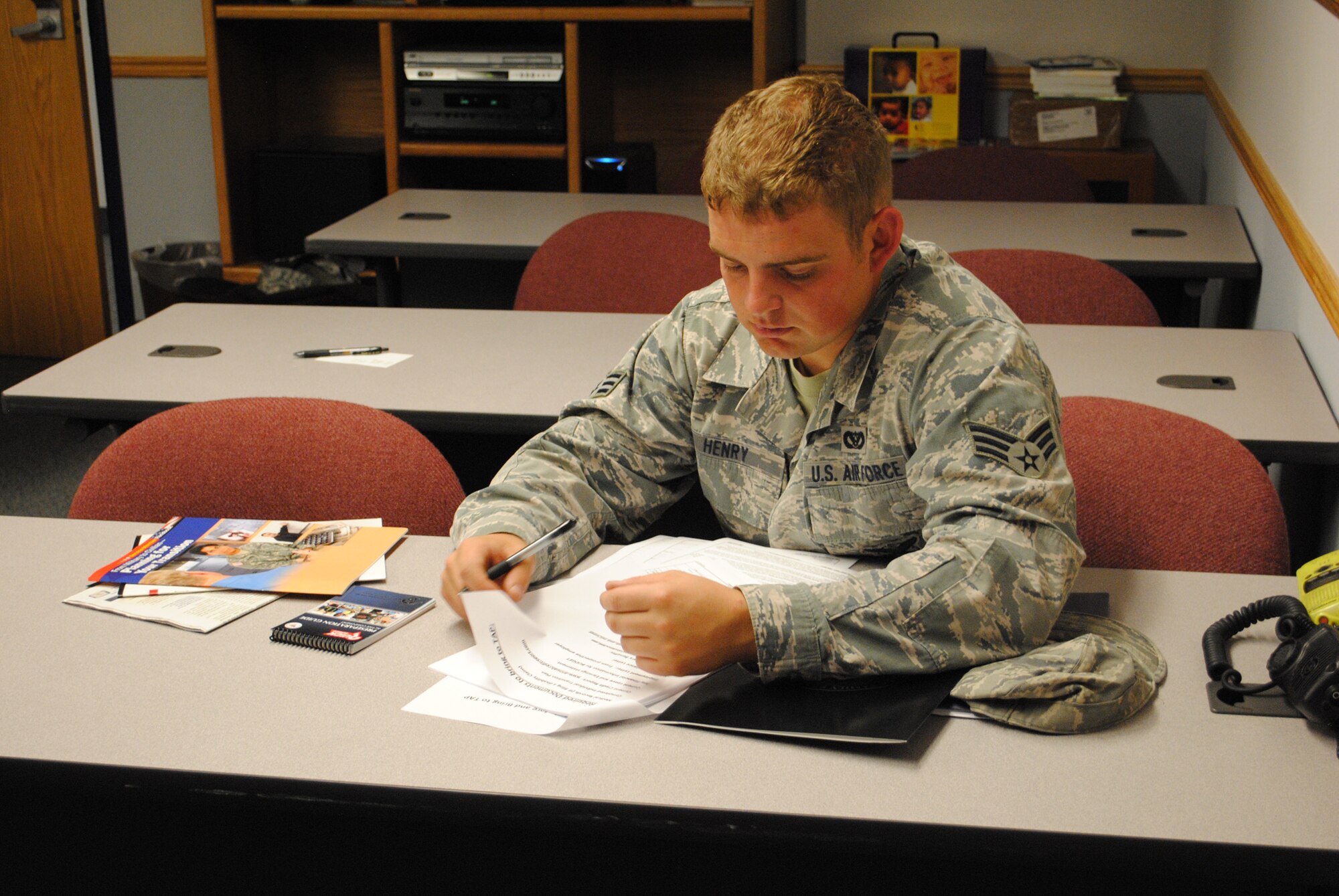 Senior Airman Zachary Henry, 341st Civil Engineer Squadron firefighter, looks through packets of Transition Assistance Program information during a pre-separations counseling briefing at the Airman and Family Readiness Center on June 20.  Department of Defense individuals separating or retiring are mandated to take the pre-separations brief and a five-day TAP Veterans Opportunity to Work workshop.  (U.S. Air Force photo/Senior Airman Cortney Paxton)