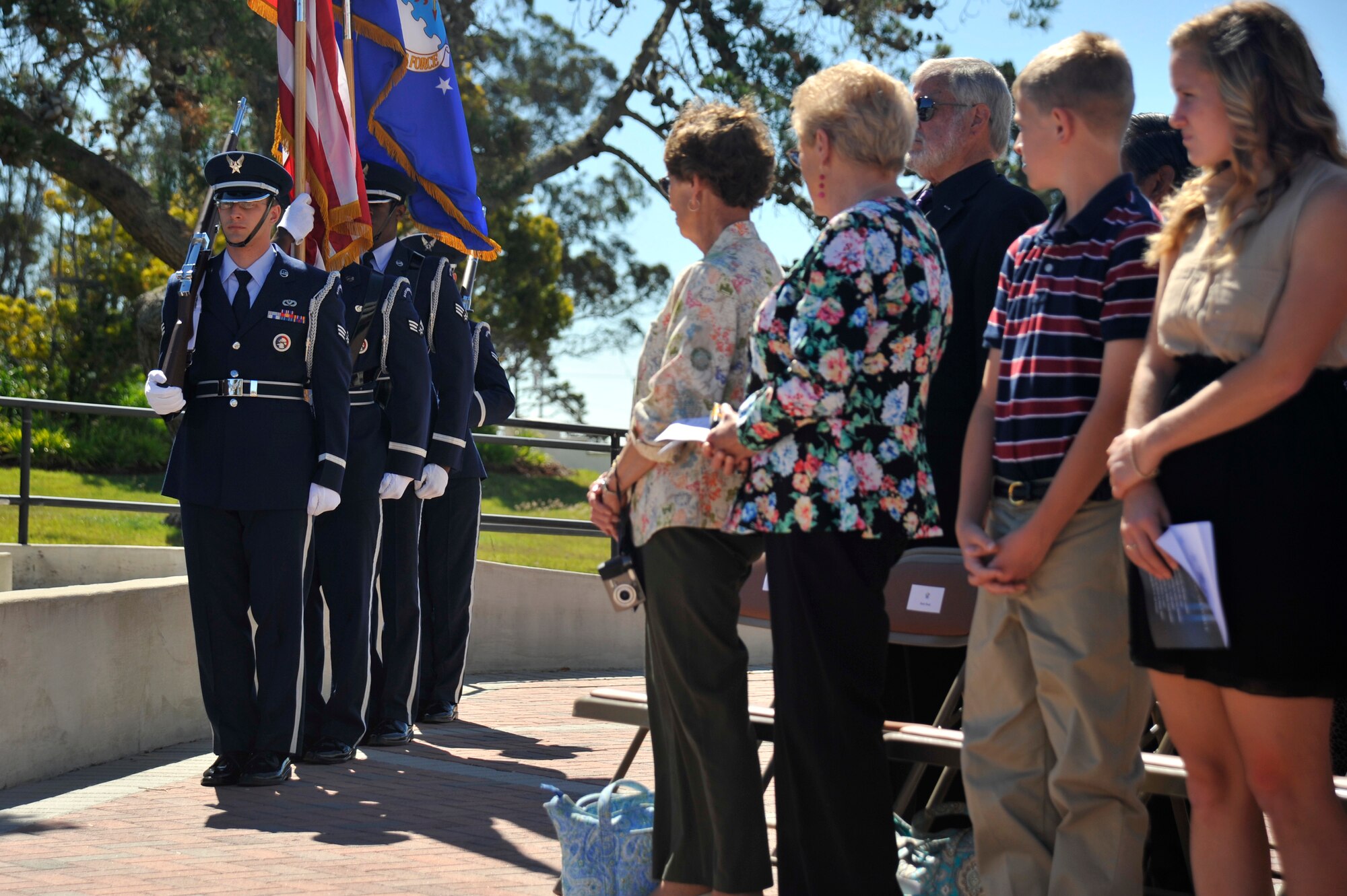VANDENBERG AIR FORCE BASE, Calif. -- Guests and family members stand as a Vandenberg color guard team prepares to post the colors during the 30th Operations Group change of command ceremony here Tuesday, June 25. The 30 OG commands and controls the Western Range and directs range resources in support of space launches, missile test launches and aeronautical and space surveillance operations. (U.S. Air Force photo/Michael Peterson)