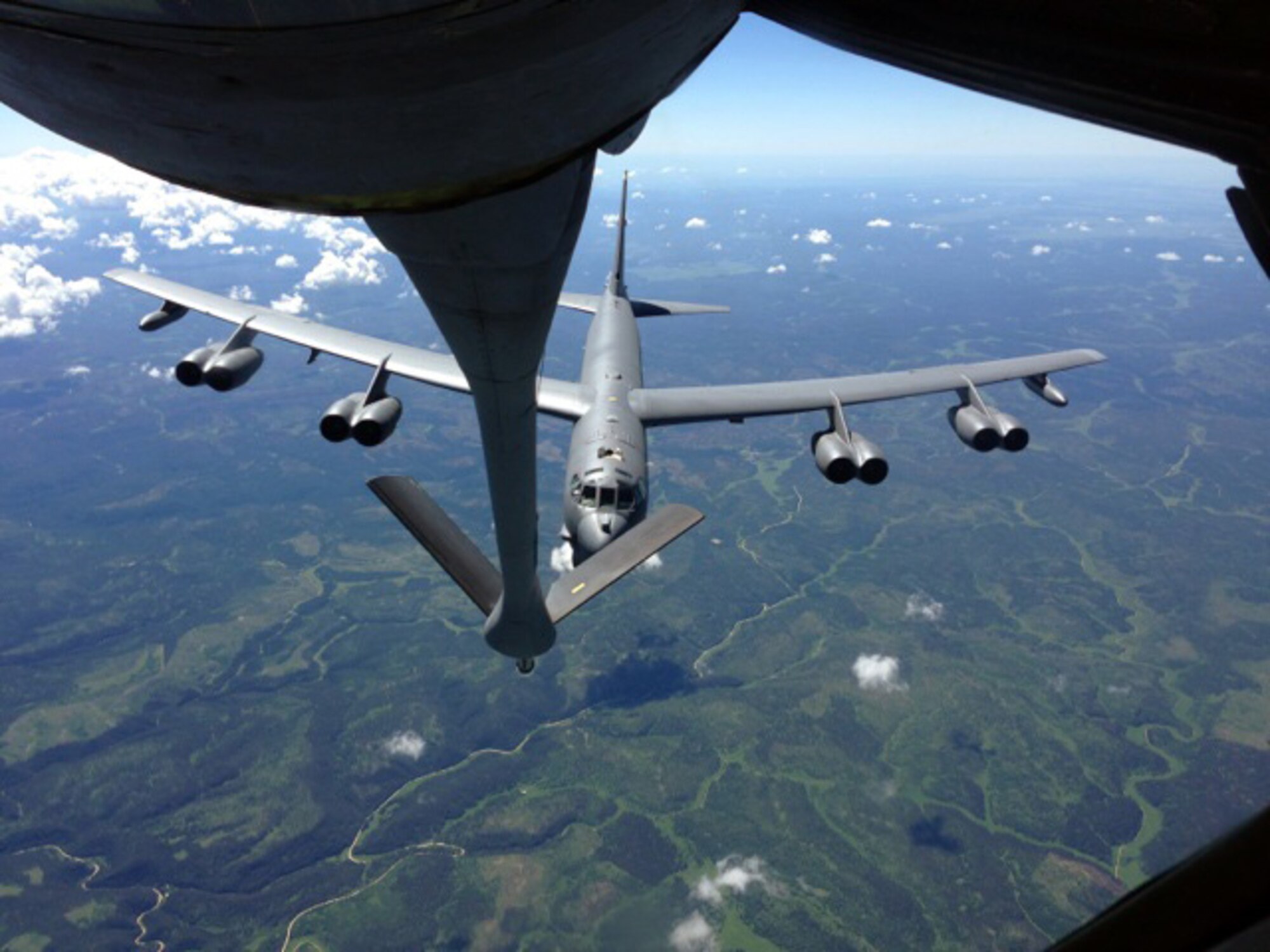 A B-52 Stratofortress assigned to the 5th Bomb Wing, Minot Air Force Base, N.D., trails behind a KC-135 Stratotanker from McConnell Air Force Base, Kan., during an air refueling training mission June 27, 2013.  The KC-135 was being operated by an aircrew made up of Reservists from the 931st Air Refueling Group at McConnell.  Air refueling training missions ensure that both the refueling and receiving aicrews maintain proficiency in air refueling operations, which allows the U.S. Air Force to extend its reach around the globe.  (U.S. Air Force photo by Senior Master Sgt. Ray Lewis)