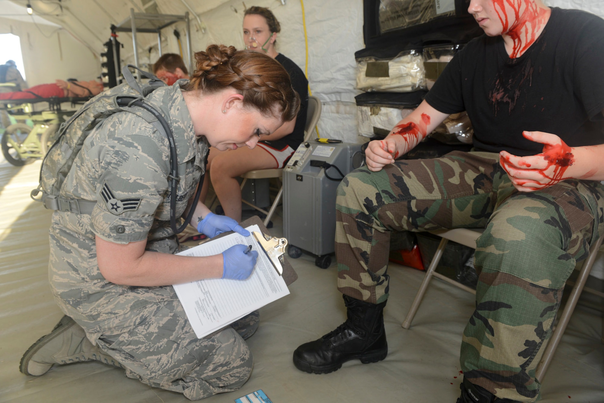 U.S. Air National Guard Senior Airman Jamison Tolbert, medical technician, 136th Medical Group, records casualty information during a mass casualty exercise at Naval Air Station Fort Worth, Joint Reserve Base, Texas, June 23, 2013. The mass casualty exercise is conducted annually to assess the readiness of the 136th Medical Group’s ability to engage in actual disaster relief. (Air National Guard photo by Master Sgt. Charles Hatton/released)