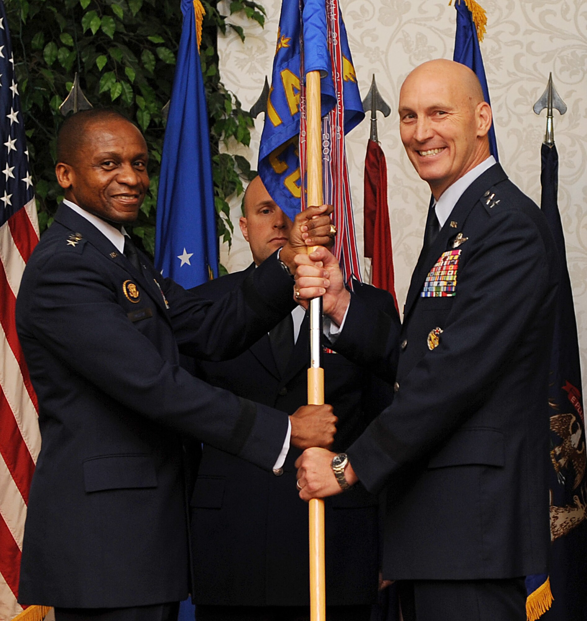 Lt. Gen. Darren McDew, 18th Air Force commander, presents the 618th Air and Space Operations Center guidon to Maj. Gen. Timothy Zadalis signifying the start of Zadalis command during a ceremony June 27, 2013 and Scott Air Force Base, Ill.  Zadalis arrived from Joint Base San Antonio Randolph, Texas, where he served as the Director of Intelligence, Operations, and Nuclear Integration. (U.S. Air Force photo/Senior Airman Divine Cox)