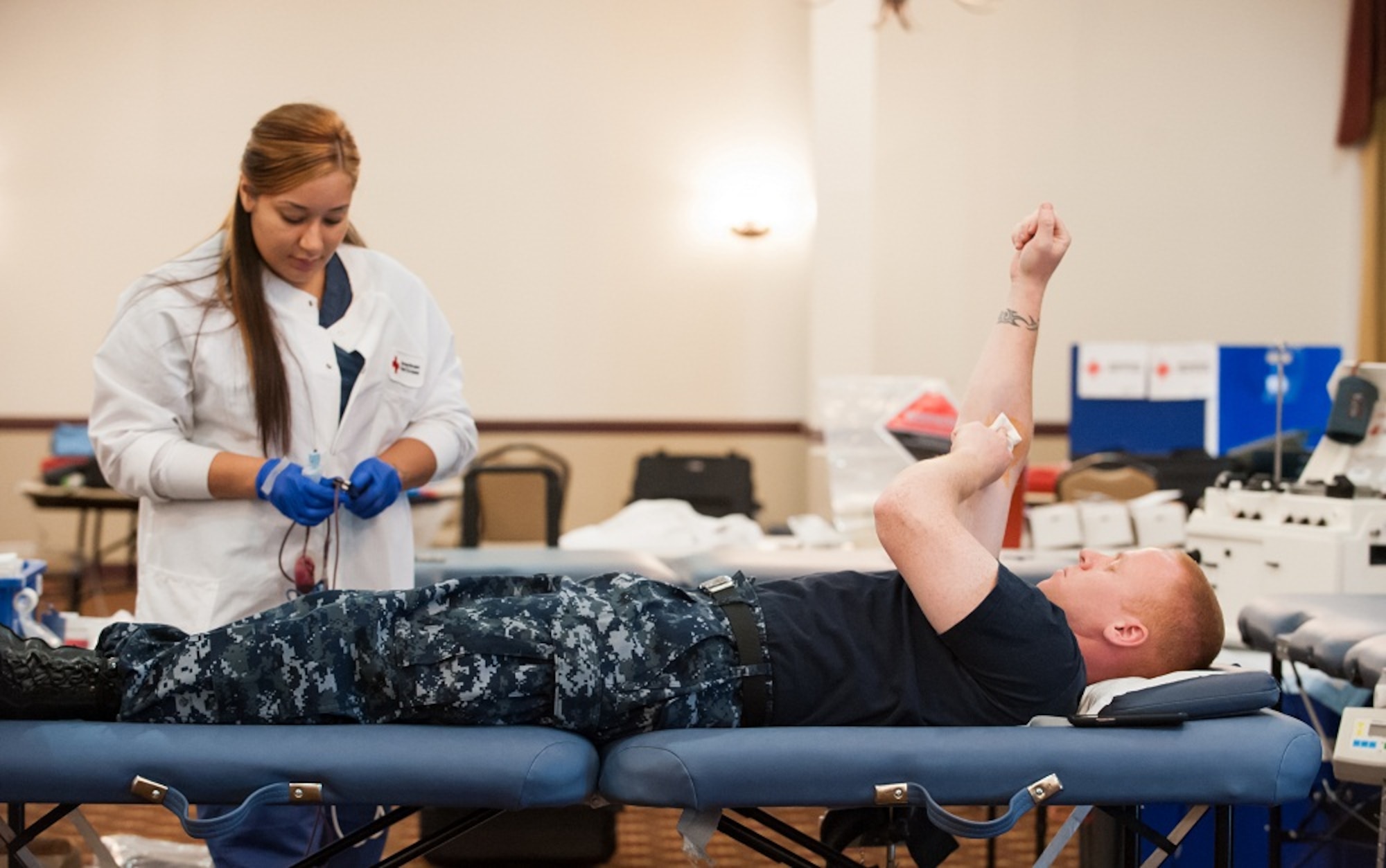 Petty Officer 1st Class Robert McCormick, Fleet Readiness Center avionics technician, donates blood as Roxy Padilla, Philadelphia Red Cross donor collection assistant phlebotomist, monitors at the American Red Cross Blood Drive June 18, 2013, at Tommy B's Community Activities Center,  Joint Base McGuire-Dix-Lakehurst, N.J. The Pennsylvania/New Jersey Red Cross is the largest contributor for Pennsylvania. (U.S. Air Force photo by Russ Meseroll/Released)