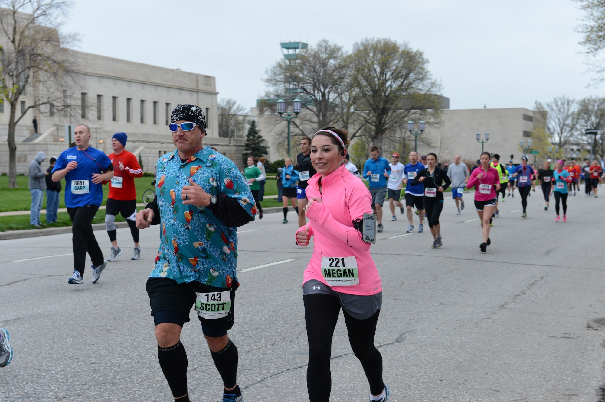 Air Force Senior Master Sgt. Scott Tontegode and Master Sgt. Megan Zuver of the 155th Air Refueling Wing Safety office pass mile one with smiles during the 36th Annual Lincoln National Guard Marathon, May 5, 2013, in Lincoln, Neb. 