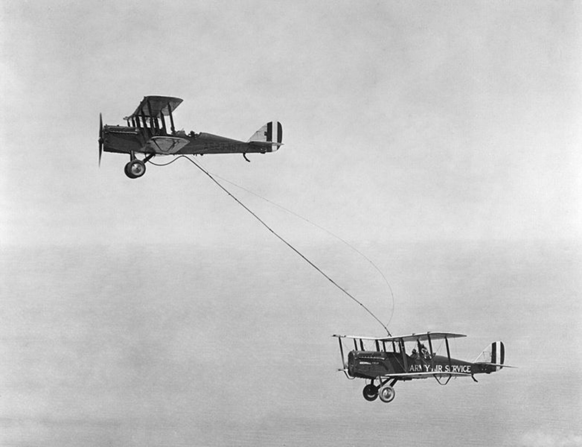 Army Air Forces members pass fuel from one aircraft to another for the first time June 28, 1923, over Rockwell Field, Calif. (U.S. Air Force photo/Released)