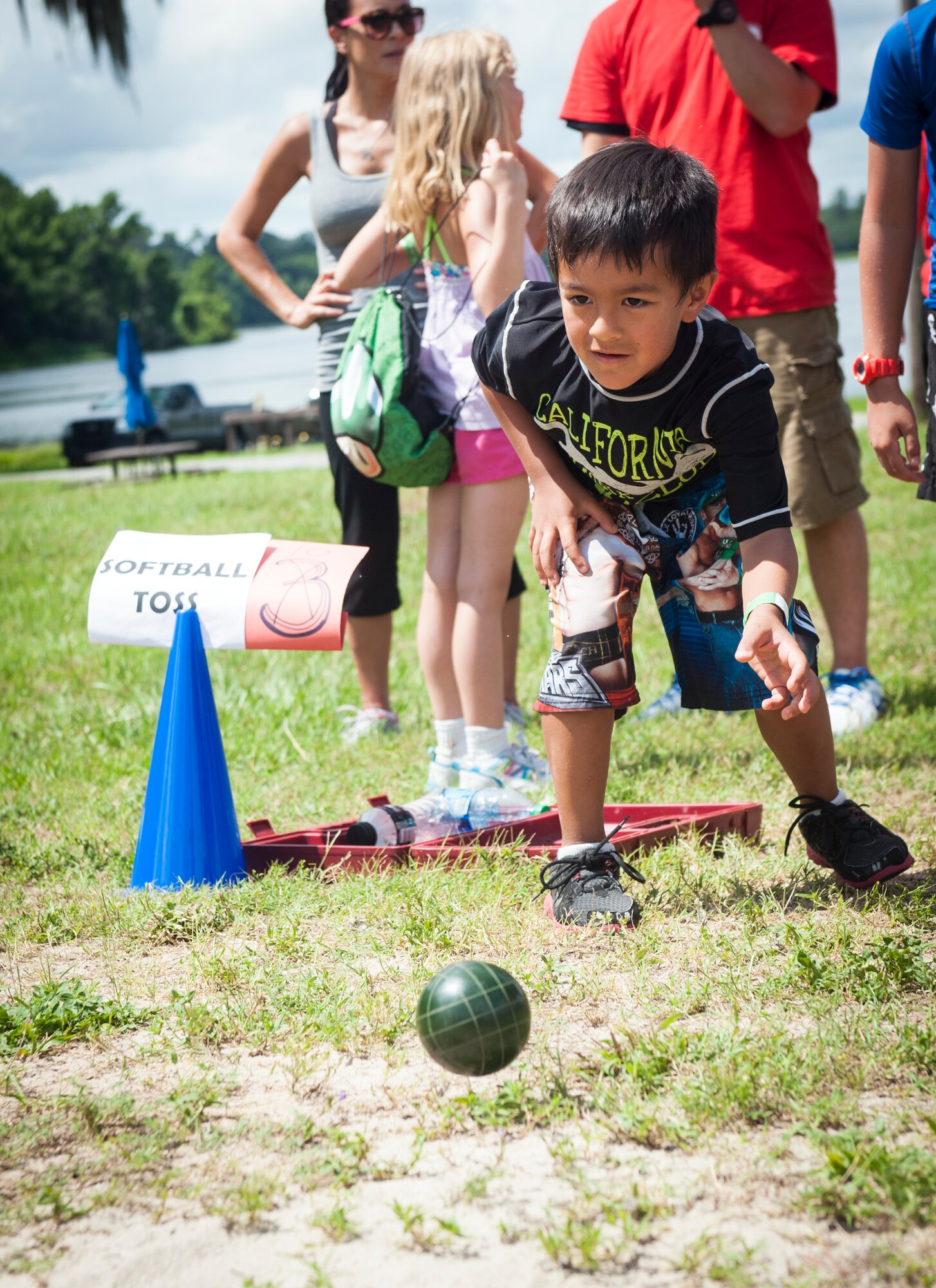 A child from Moody Air Force Base, Ga., rolls a bocce ball during a Children’s Olympics event June 21, 2013 at Grassy Pond in Lake Park, Ga. U.S. Army Sgt. 1st Class Joshua Olson, the first active-duty soldier to compete in the Paralympics, was a special guest at the event, which was hosted by the Moody Youth Programs. (U.S. Air Force photo by Senior Airman Jarrod Grammel/Released)
