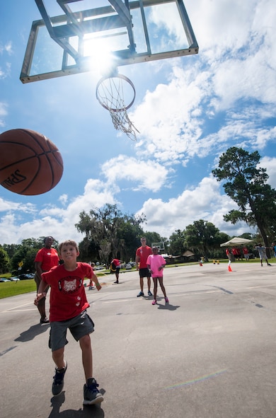 Children from Moody Air Force Base, Ga., play basketball war during a Children’s Olympics event June 21, 2013 at Grassy Pond in Lake Park, Ga. The Children’s Olympics was designed to help foster the Olympic spirit and bring together children from Team Moody. (U.S. Air Force photo by Senior Airman Jarrod Grammel/Released)
