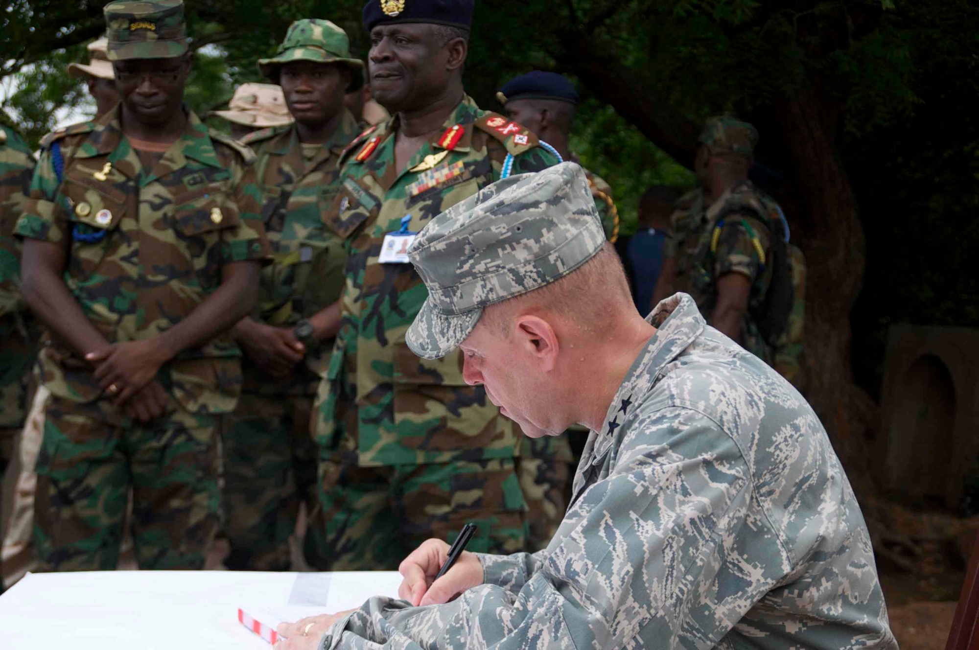Maj. Gen. Eric Vollmecke, Western Accord 13 deputy exercise director, signs the distinguished visitors log while touring the Bundase training camp near Accra, Ghana, June 19. Western Accord 13 is a mutually beneficial exercise hosted by U.S. Army Africa that brings together the Economic Community of West African States and the US Army to have increased capabilities to support regional peacekeeping operations. (Photos by: Sgt. Tyler Sletten, 116th Public Affairs Detachment)