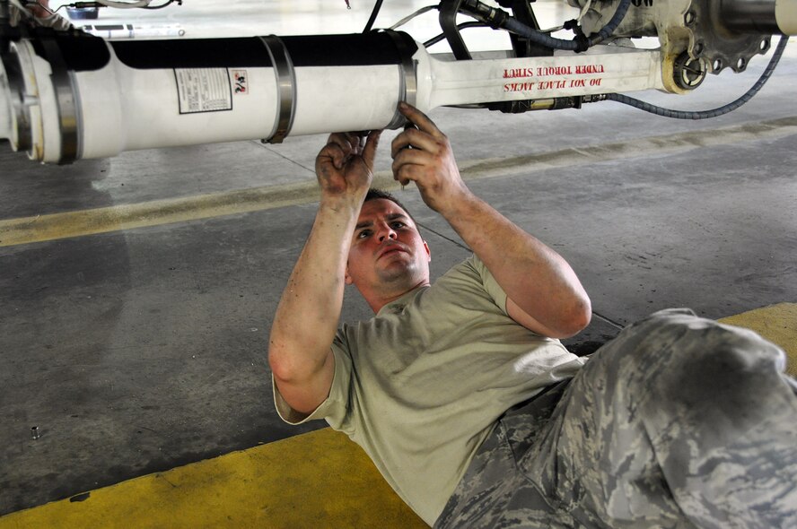 Tech Sgt. Lucas Phillips, 911th Airlift Wing Aircraft Maintenance Squadron crew chief, installs brake lines on the new Mark IV braking system, which is now the standard on all aircraft at the Pittsburgh International Airport Air Reserve Station, May 22, 2013. (U.S. Air Force photo by Senior Airman Joseph E. Bridge)