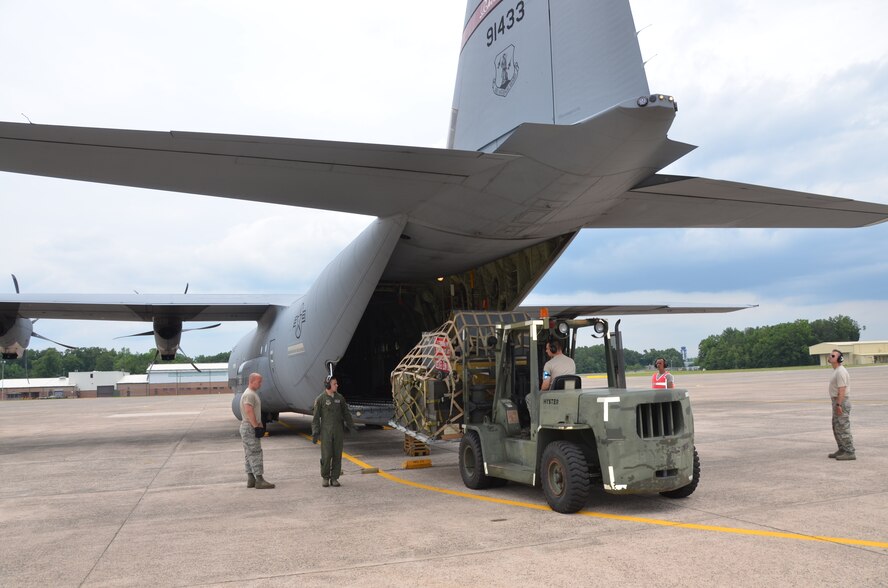 Members of the Connecticut Air National Guard's 103rd Logistics Readiness Squadron off load a Rhode Island Air National Guard C-130 at Bradley Air National Guard Base, East Granby, Conn., June 26, 2013. The 103rd partnered with the Rhode Island unit to have maintenance equipment transported from Ohio in preparation for Connecticut's future C-130 mission. (U.S. Air National Guard photo by Maj. Jefferson S. Heiland)