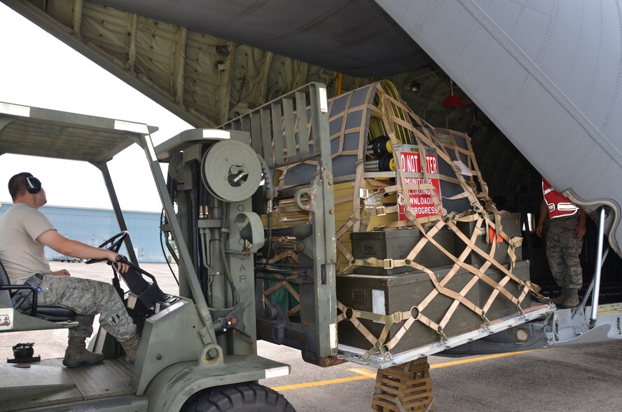 Members of the Connecticut Air National Guard's 103rd Logistics Readiness Squadron off load a Rhode Island Air National Guard C-130 at Bradley Air National Guard Base, East Granby, Conn., June 26, 2013. The 103rd partnered with the Rhode Island unit to have maintenance equipment transported from Ohio in preparation for Connecticut's future C-130 mission. (U.S. Air National Guard photo by Maj. Jefferson S. Heiland)