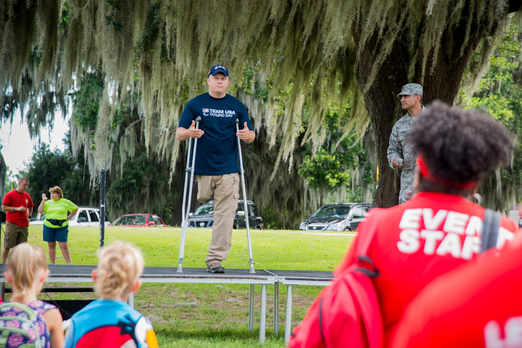 U.S. Army Sgt. 1st Class Joshua Olson, Army Marksmanship Unit international rifle shooter out of Fort Benning, Ga., gives remarks to kick off Olympic Day at Moody Air Force Base, Ga., June 21, 2013. Olson lost his right leg in an ambush during Operation Iraqi Freedom in 2003 and started competitive shooting in 2005. (U.S. Air Force photo by Staff Sgt. Jamal D. Sutter/Released)  