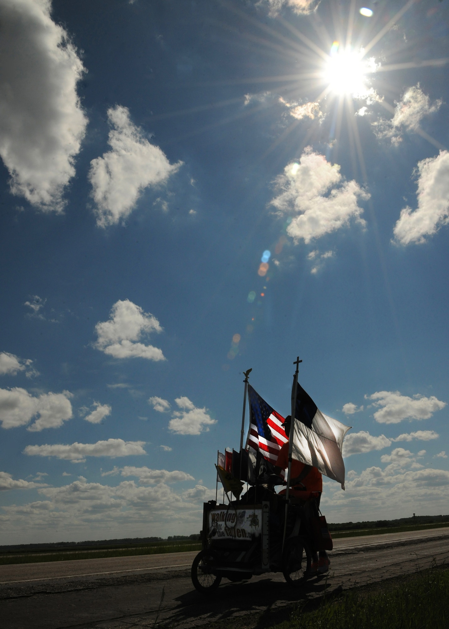 On his way to the Vietnam Veterans Memorial wall in Washington, D.C., military veteran Sgt. Chuck Lewis travels near Grand Forks Air Force Base, N.D. on June 13, 2013. Lewis began a 3,300-mile journey across the United States on March 31, 2013, to raise money for wounded and disabled veterans.  (U.S. Air Force photo/Airman 1st Class Ashley Nicole Taylor)