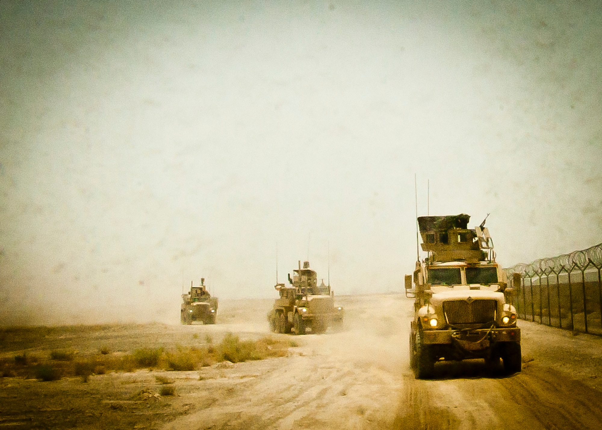 A joint-coalition convoy departs Kandahar Airfield, Afghanistan, to dispose of excess military ordnance June 12, 2013. Romanian soldiers provided security for the mission, while U.S. Air Force, U.S. Army, Slovakian and Australian explosive ordnance disposal personnel conducted the controlled detonations, which was an example of the working partnerships between the allied countries. (U.S. Air Force photo/Senior Airman Scott Saldukas)