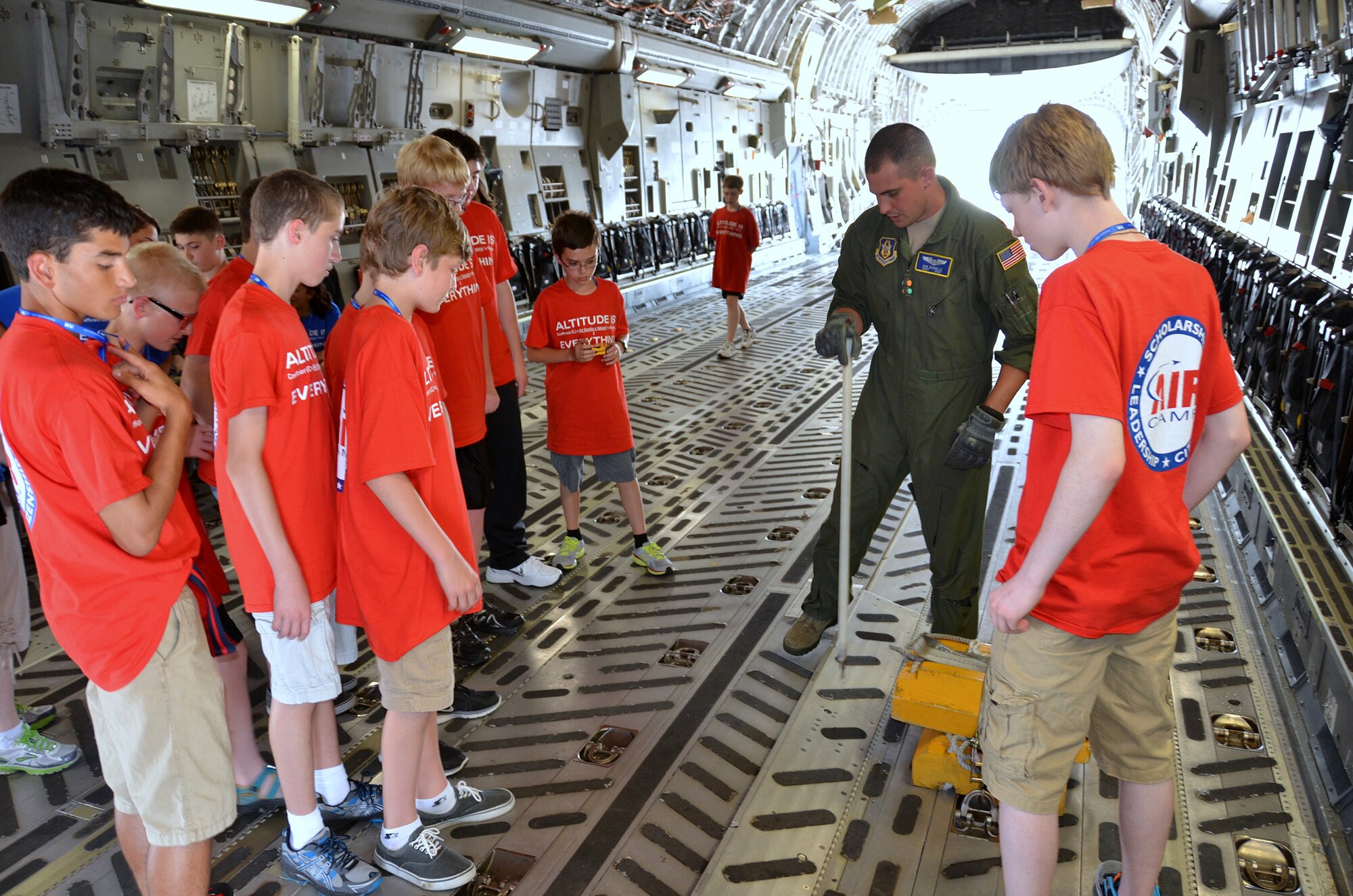 WRIGHT-PATTERSON AIR FORCE BASE, Ohio – Staff Sgt. Rob Schnelle, 89th Airlift Squadron loadmaster, shows participants from the 2013 Air Camp the cargo area of a C-17 Globemaster III during the group’s visit to the 445th Airlift Wing June 17. Air Camp is a week-long summer camp for middle school students to learn about aviation and the science, technology, engineering and mathematics of aeronautics. The program is the vision of Dayton-area leaders who want to help young people nationwide achieve their potential, develop critical-thinking and problem-solving skills, and pursue further education and future careers in STEM-related fields and aviation. (U.S. Air Force photo/Master Sgt. Charles Miller)