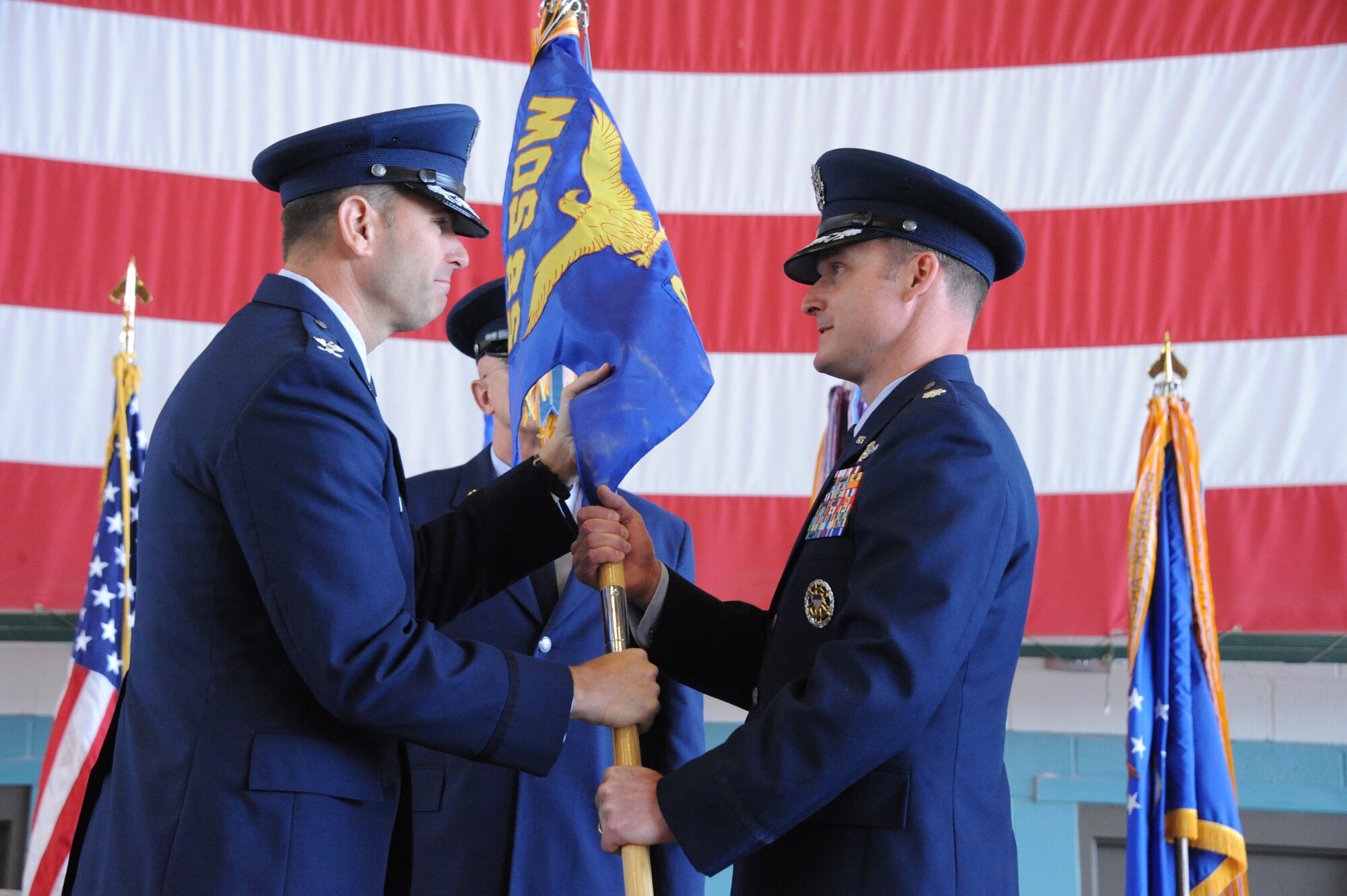 Lt. Col. Arthur Davis, right, takes the guidon from Col. Vincent Becklund, 58th Special Operations Wing commander, at a change of command ceremony June 21. Davis is the new commander of the 58th Operations Group. (Photo by Todd Berenger)