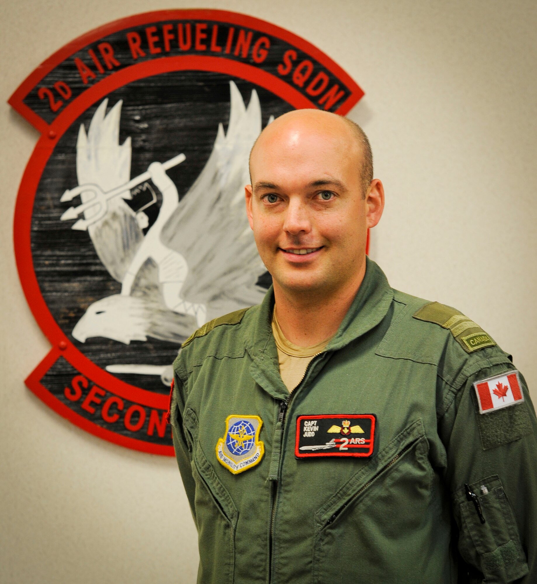 Capt. Kevin Judd, 2nd Air Refueling Squadron KC-10 Extender pilot, stands in front of the unit’s shield June 10, 2013, at Joint Base McGuire-Dix-Lakehurst, N.J., here. The Royal Canadian Air Force CC-150 Polaris pilot from Deep River, Ontario, has been flying with the 2nd ARS for the past two years as part of the three-year Military Personnel Exchange Program.  Judd has one more year here at JB MDL before returning to the 437 Transport Squadron in Canada as the head of training. (U.S. Air Force photo by Airman 1st Class Ryan Throneberry/Released)