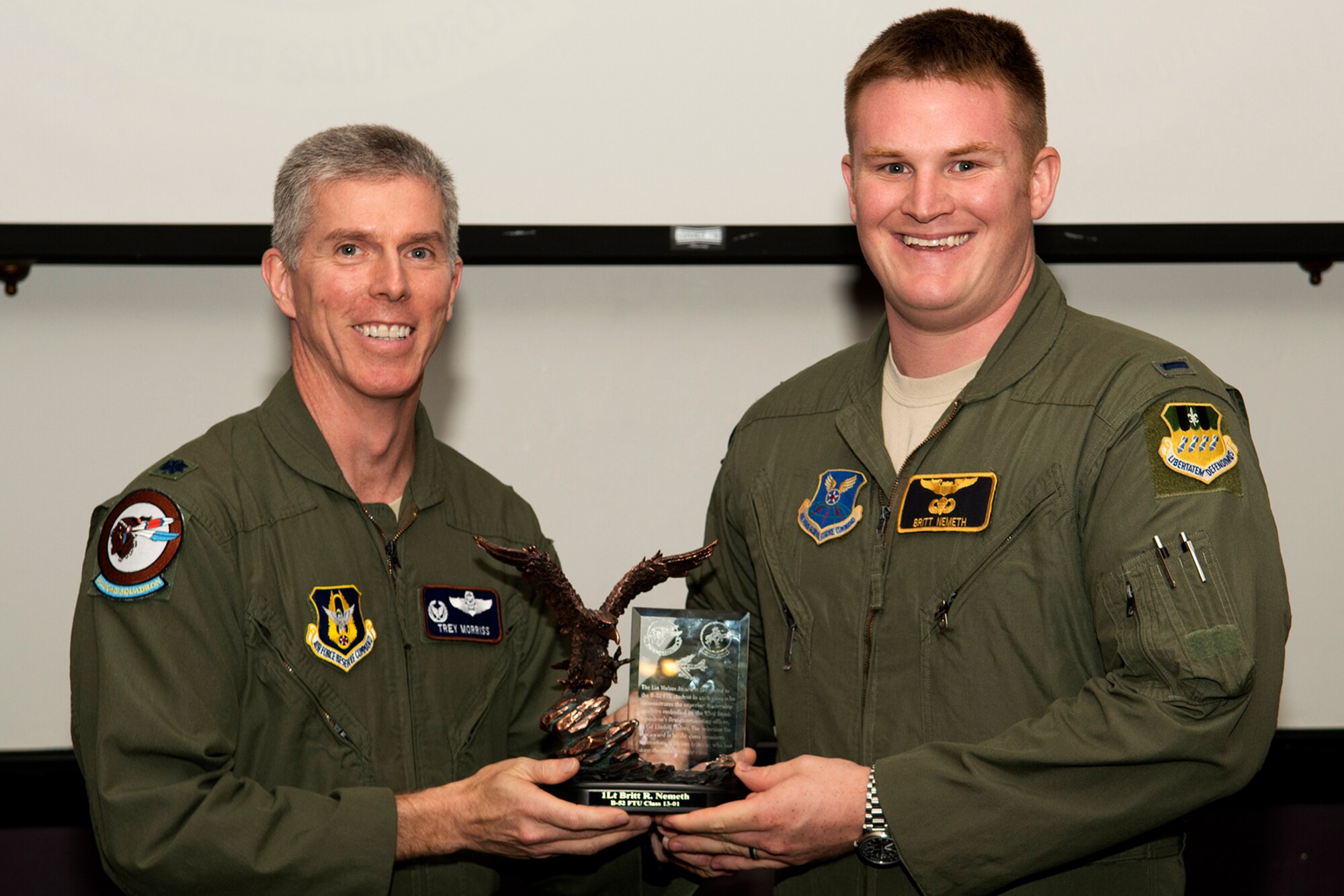 U.S. Air Force Lt. Col. James Morriss, 93rd Bomb Squadron commander, presents the Lindell Mabus Leadership Award to 1st Lt. Britt Nemeth during a Formal Training Unit graduation ceremony, June 14, 2013, Barksdale Air Force Base, La. Nemeth was selected by his fellow classmates for his exceptional leadership which was critical to the class's graduation. (U.S. Air Force photo by Master Sgt. Greg Steele/Released)