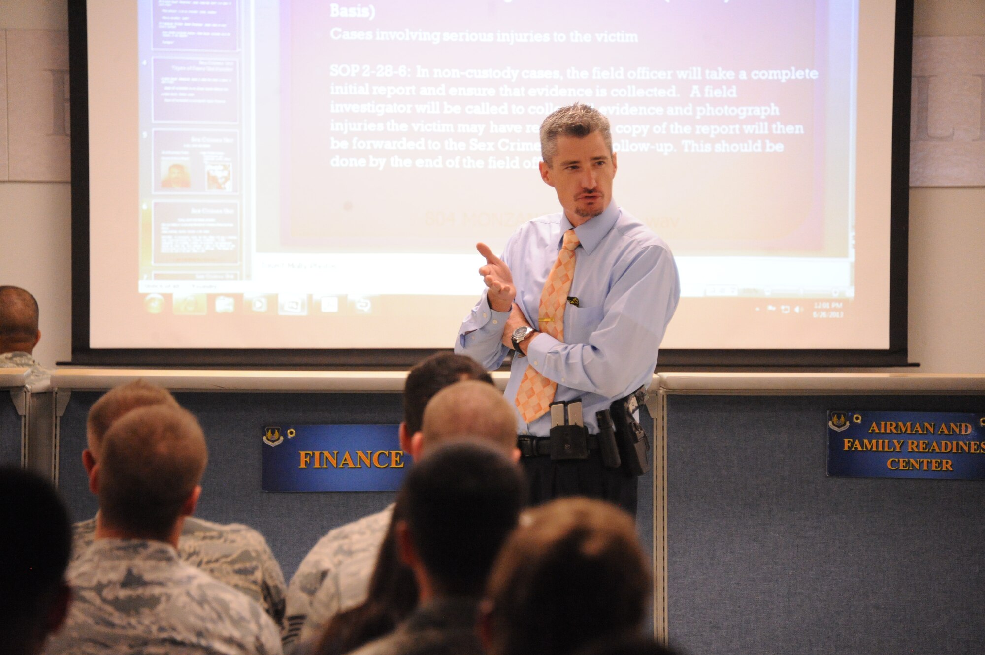 Sergeant Glenn St. Onge of the Albuquerque Police Department’s Violent Crimes Division, Sex Crime Unit, briefs members of the 377th Logistics Readiness Squadron at a Sexual Assault Prevention and Response Stand-Down Day June 27.  The day’s events -- directed by the secretary of defense and top Air Force leaders -- included interactive commander’s calls and small-group training sessions across the installation. (Photo by Todd Berenger)