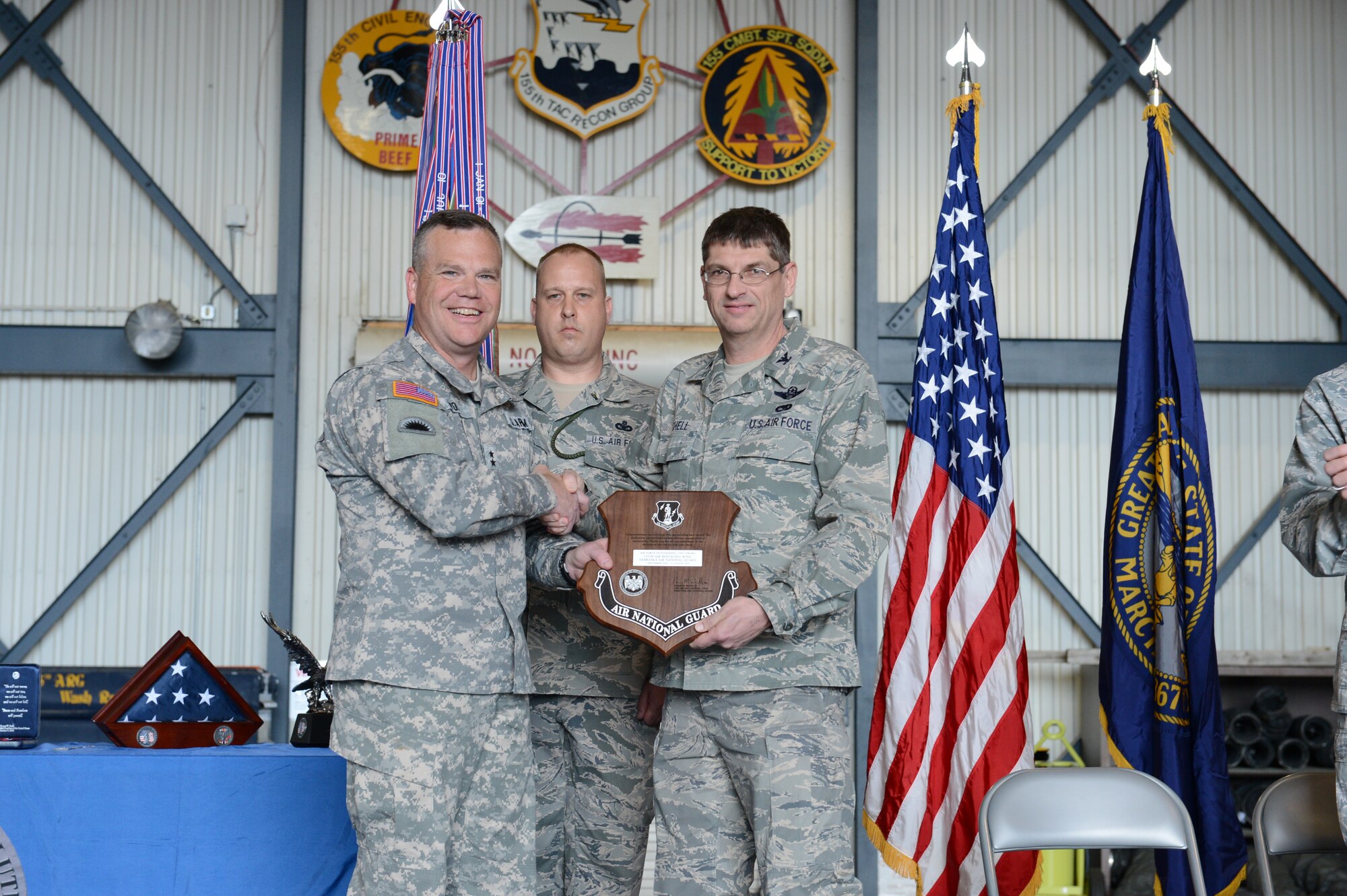 Maj. Gen. Judd Lyons, Nebraska National Giuard's adjutant general, awards Col. Keith Schell, commander of the 155th Air Refueling Wing with an Outstanding Unit award for fiscal year 2012 at the Hometown Heroes Salute ceremony April 6, 2013, at the Nebraska National Guard air base, Lincoln, Neb. The purpose of the ceremony is to honor family members and unit members who had deployed, for their sacrifices made.