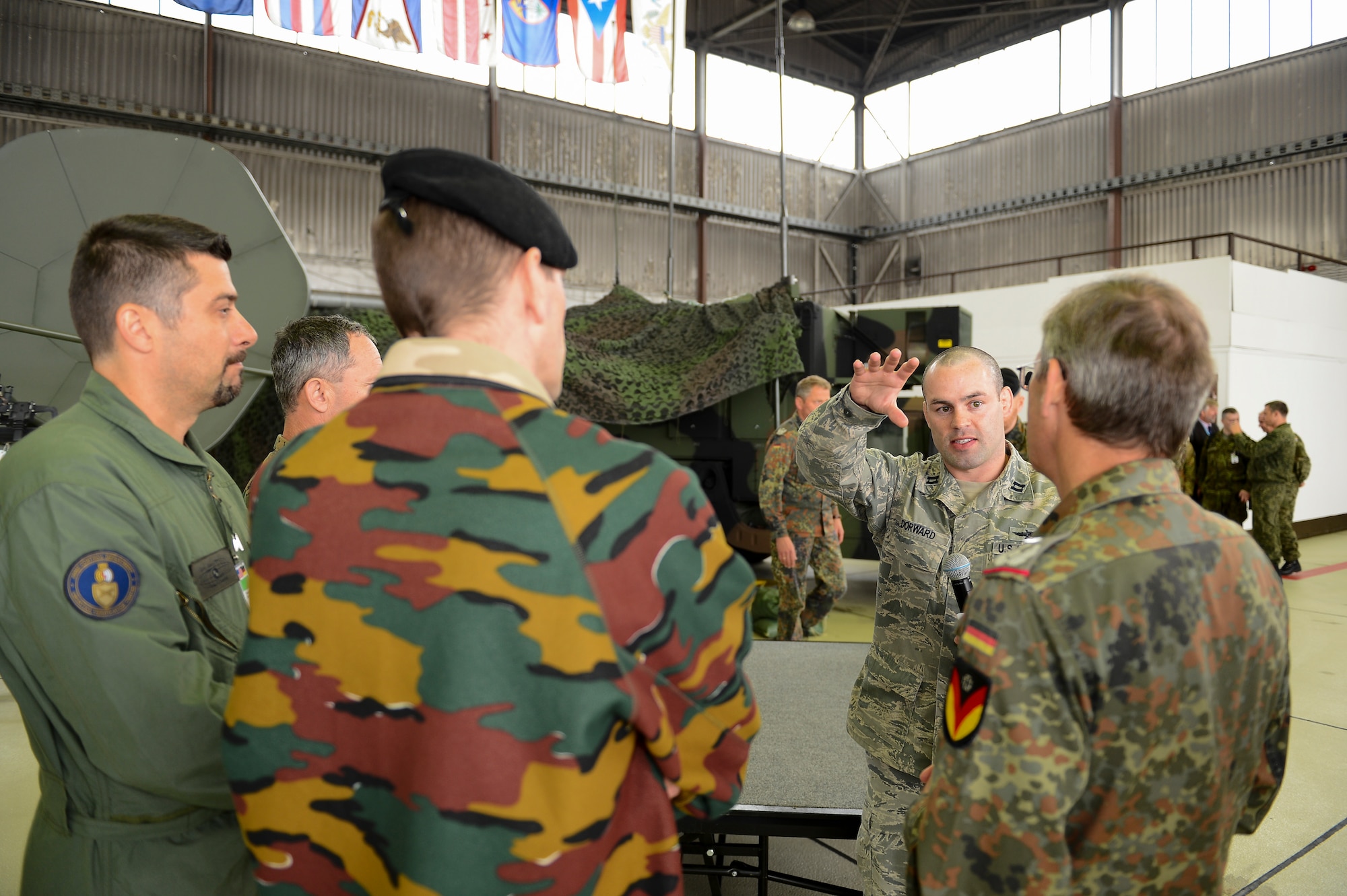 SPANGDAHLEM AIR BASE, Germany -- U.S. Air Force Capt. Anthony Doward, 606th Air Control Squadron modular system flight commander, briefs delegates from 34 nations of  606th ACS missions and capabilities June 27, 2013 during the Vienna Document 11 visit held at Spangdahlem Air Base. This is the first time Spangdhalem AB hosted a Vienna Document visit. During the visit international delegates saw first-hand how Spangdahlem provides safety and security throughout the region, and supports combat missions. (U.S. Air Force photo by Tech. Sgt. Jonathon Pomeroy/Released)