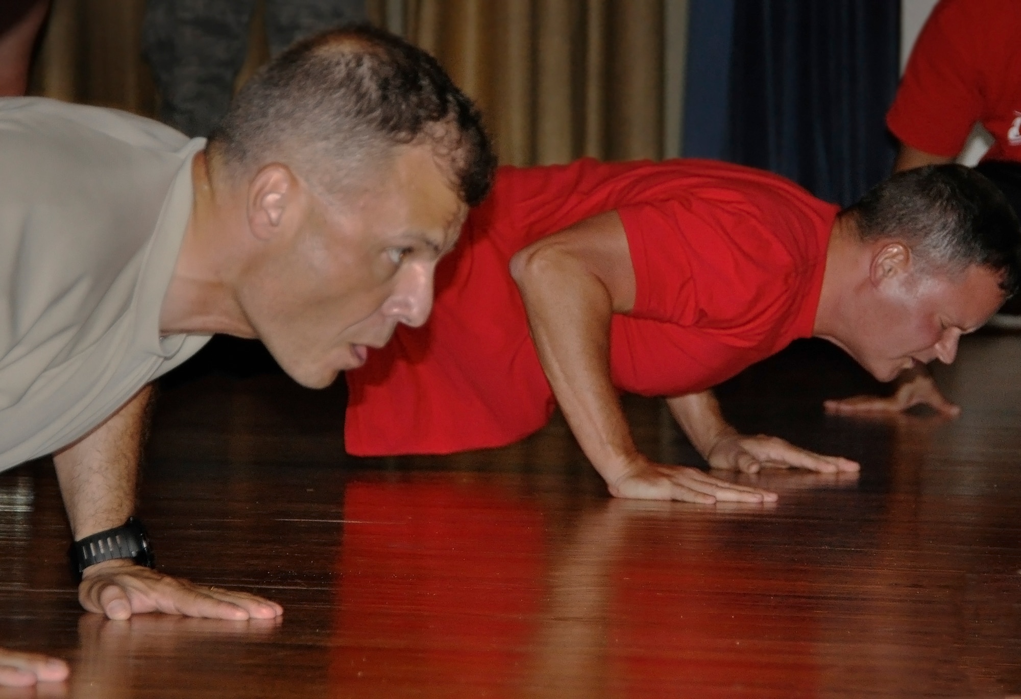 Maj. Miroslav Karamarinov, of the 96th Civil Engineer Squadron, faces off against Senior Master Sgt. Gary Walters, of the 96th Medical Support Squadron, at the 96th Test Wing pushup competition held June 21 at the Eglin Enlisted Heritage Hall. The Operations Group claimed the victory by edging out the Medical Group in the final round. (U.S. Air Force photo/Sara Vidoni)
