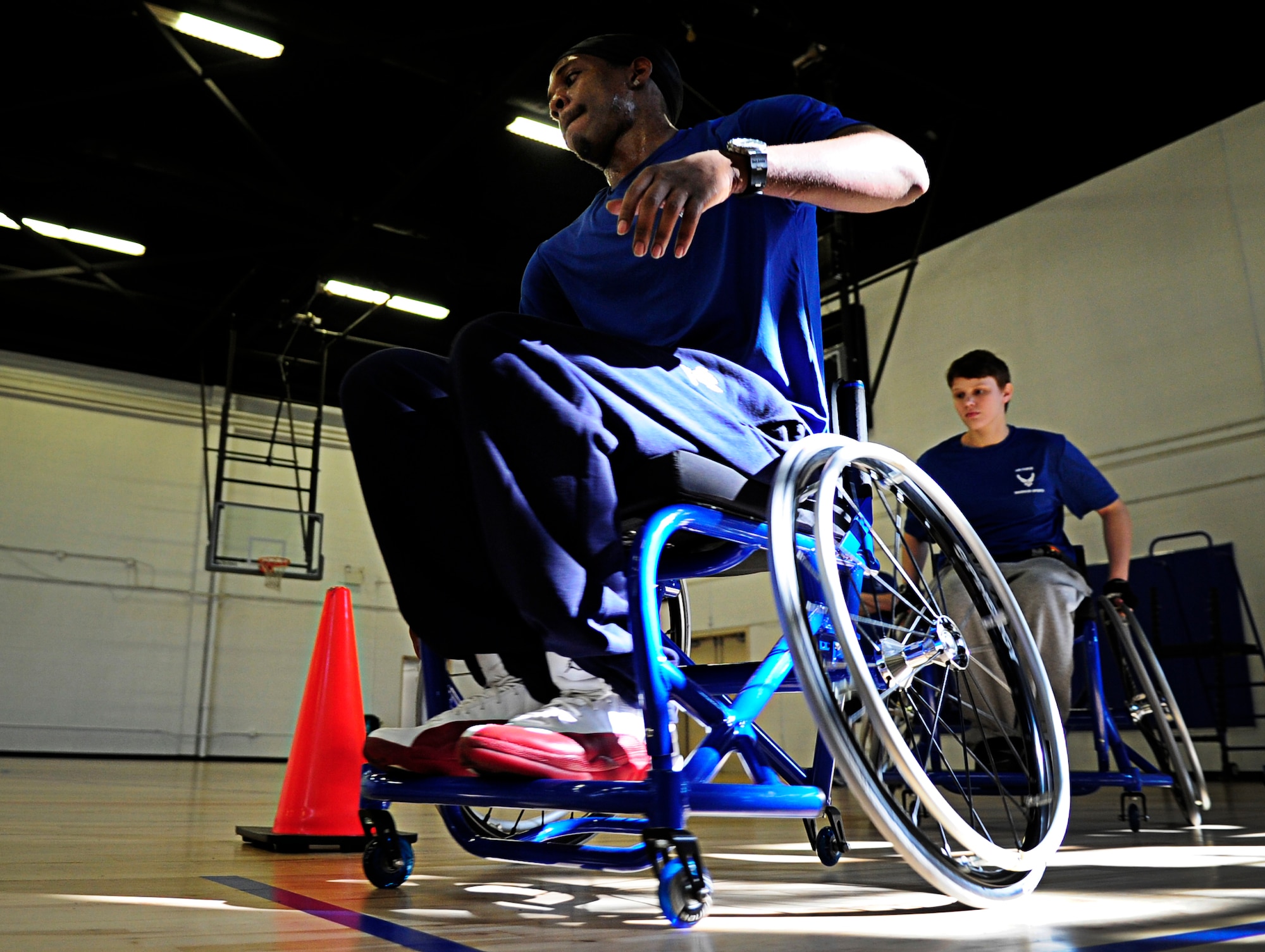 Wounded Warriors learn to maneuver through cones in a wheelchair before playing a game of wheelchair basketball during an Air Force Wounded Warrior Adaptive Sports Training Camp at the West Fitness Center at Joint Base Andrews, Md., June 26, 2013. (U.S. Air Force photo/Senior Airman Lauren Main)