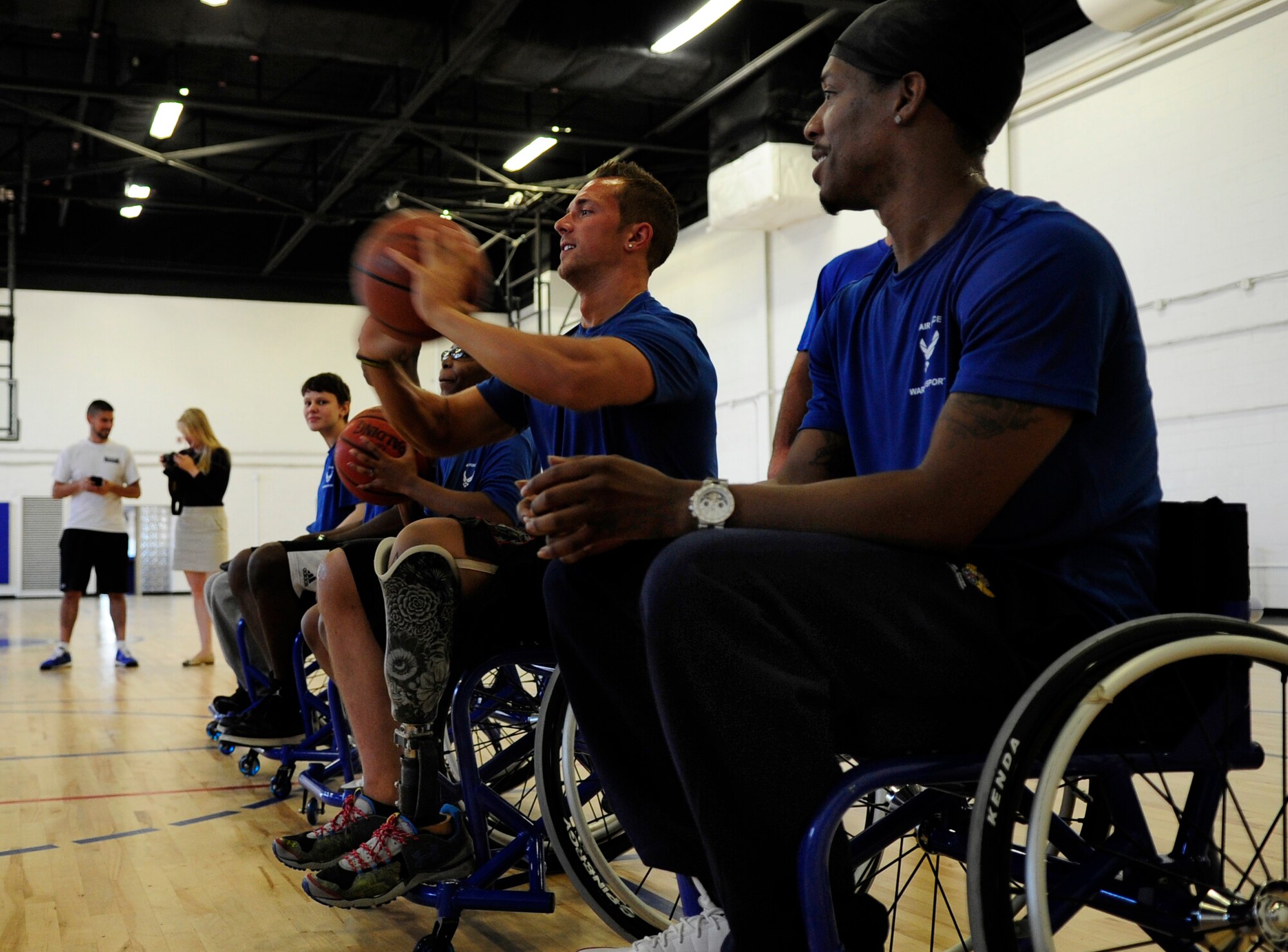 Wounded Warriors learn the fundamentals of wheelchair  basketball prior to playing a game during an Air Force Wounded Warrior Adaptive Sports Training Camp at the West Fitness Center at Joint Base Andrews, Md., June 26, 2013. (U.S. Air Force photo/Senior Airman Lauren Main)