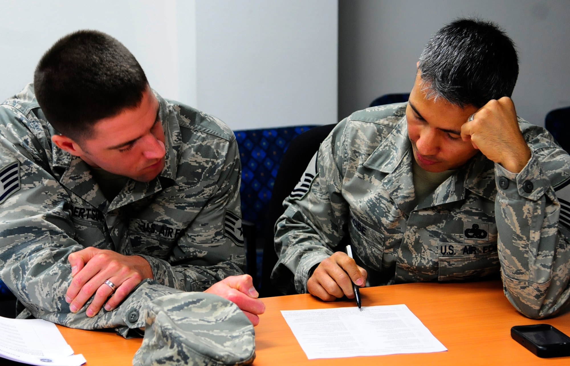RAMSTEIN AIR BASE, Germany-- Master Sgt. Matthew Hose (right), Master Resilience Trainer for the 521st Air Mobility Operations Wing, goes through a resilience training workbook with a fellow Airmen. The 521st AMOW has trained over 97 percent of its wing in resilience skills, well ahead of Air Mobility Command's goal to have 80 percent of active duty Airmen trained by the end of 2013. (Courtesy Photo/Released)