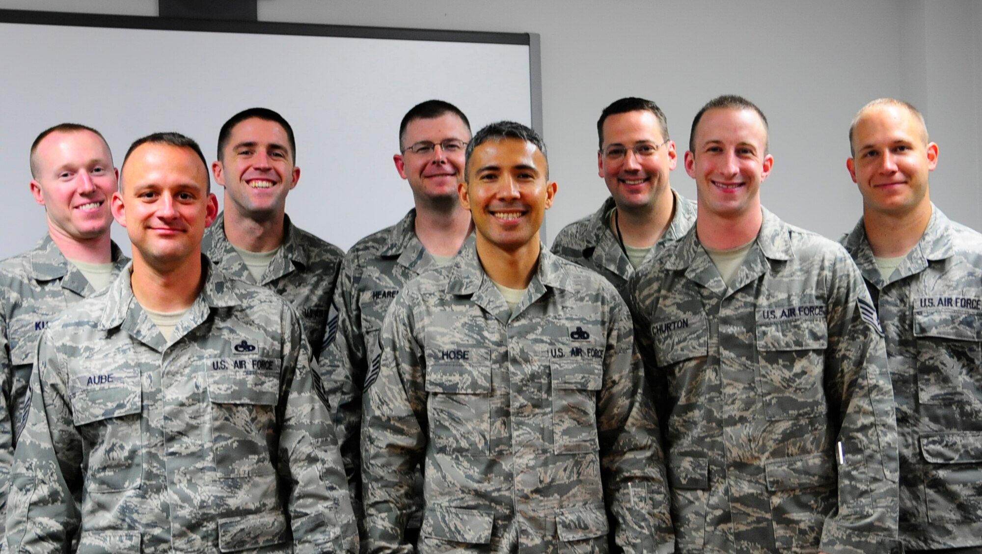 RAMSTEIN AIR BASE, Germany-- Members of the 521st Air Mobility Operations Wing resilience training team pose for a group photo after surpassing Air Mobility Command's goal to train 80 percent of active duty members in resilience skills by the end of 2013. (Front row, from left to right.) Master Sgt. Mark Aube, of the 721st Air Mobility Maintenance Squadron; Master Sgt. Matthew Hose, 521st AMOW Master Resilience Trainer; Staff Sgt. Casey Churton, of the 721st Aerial Port Squadron; (Second row) Staff Sgt. Kevin Kust, Tech. Sgt. Clifton Robertson and Master Sgt. Ira Hearen, all of the 721st APS; Senior Master Sgt. Jack Johns, of the 721st AMXS; and Staff Sgt. John Austin, of the 313th Expeditionary Operations Support Squadron, trained over 97 percent of wing personnel in the pillars of Comprehensive Airmen Fitness. (Courtesy Photo/Released)