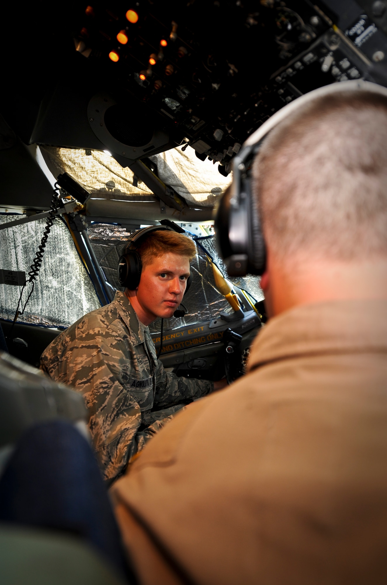 Capt. Eric Penney explains flight controls and general aircraft operations to Cadet Scott Agnolutto on board a KC-135 Stratotanker at the 379th Air Expeditionary Wing in Southwest Asia, June 24, 2013. Penney is a 340th Expeditionary Air Refueling Squadron pilot deployed from McConnell Air Force Base, Kan. More than 40 U.S. Air Force Academy cadets visited the 379th AEW in June observing deployed operations first-hand and interacting with deployed U.S. and coalition forces. (U.S. Air Force photo/Senior Airman Benjamin Stratton)