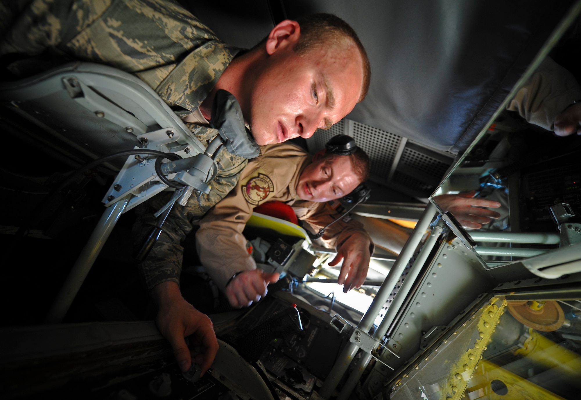 Staff Sgt. Samuel Martinez shows Cadet Aubry Eaton how to operate the boom controls on board a KC-135 Stratotanker at the 379th Air Expeditionary Wing in Southwest Asia, June 24, 2013. Martinez is a 340th Expeditionary Air Refueling Squadron boom operator deployed from McConnell Air Force Base, Kan. More than 40 U.S. Air Force Academy cadets visited the 379th AEW in June observing deployed operations first-hand and interacting with deployed U.S. and coalition forces. (U.S. Air Force photo/Senior Airman Benjamin Stratton)