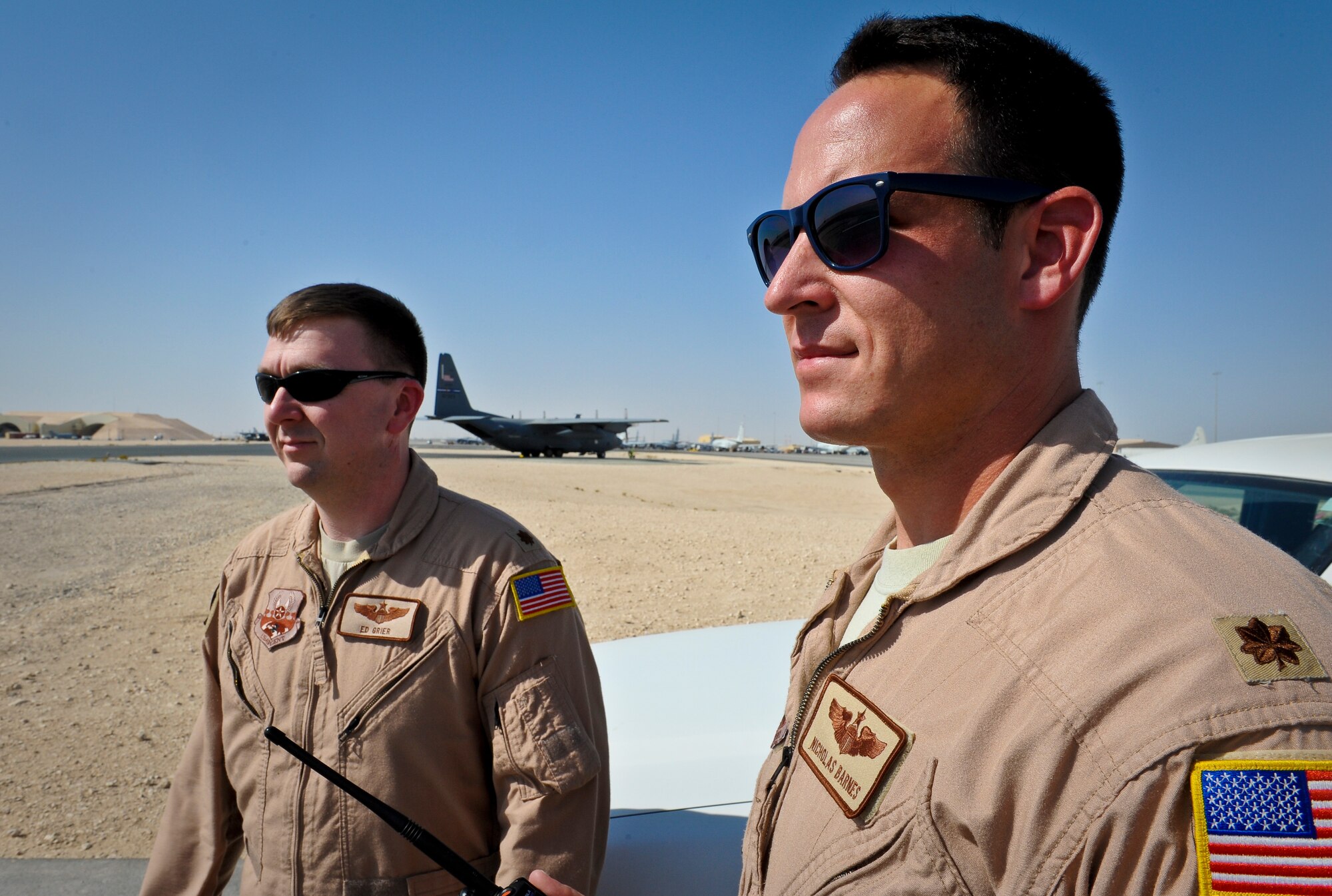 Majs. Ed Grier and Nicholas Barnes respond to a potential flight safety incident at the 379th Air Expeditionary Wing in Southwest Asia, June 25, 2013. Grier and Barnes are both 379th AEW flight safety officers. Grier is a C-17 pilot deployed from Joint Base Charleston, S.C., and Barnes is a C-40 pilot deployed from Joint Base Pearl Harbor-Hickam, Hawaii. (U.S. Air Force photo/Senior Airman Benjamin Stratton)