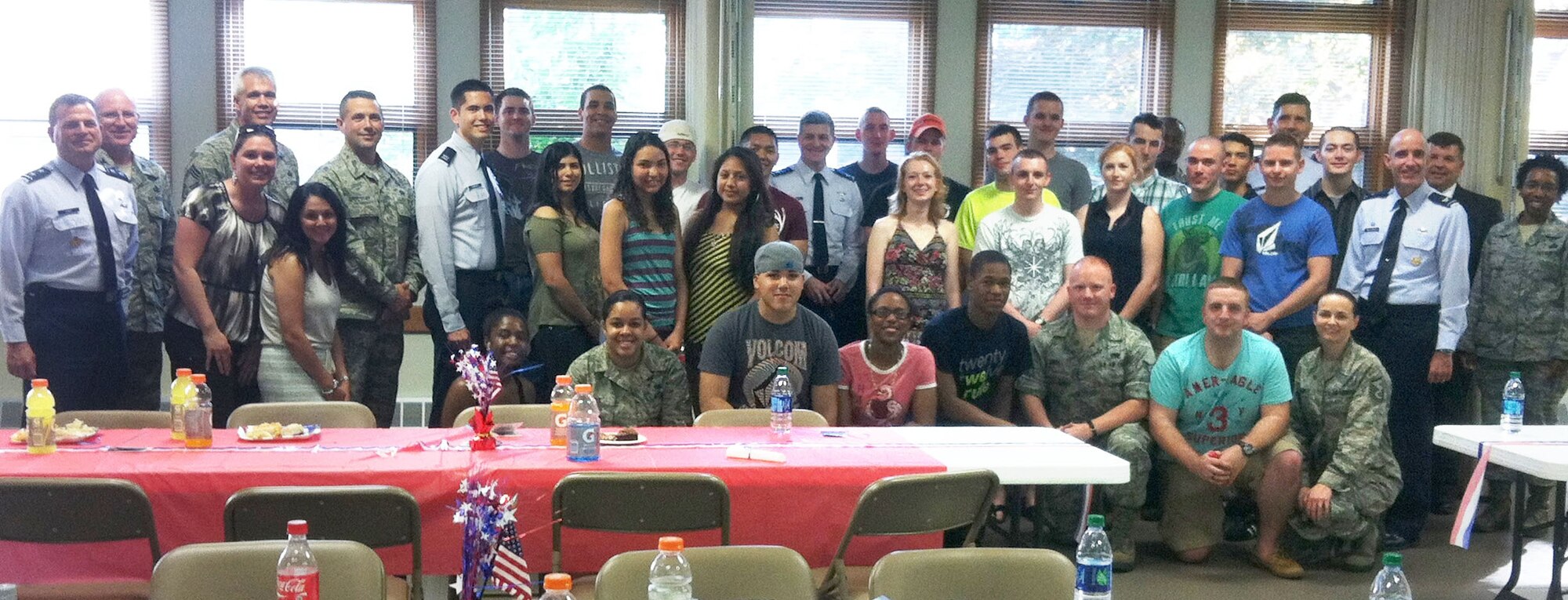 HANSCOM AIR FORCE BASE, Mass. -- Air Force Life Cycle Management Center Commander Lt. Gen. C.D. Moore II (back row right), Program Executive Officer for Fighters and Bombers Maj. Gen. Dwyer L. Dennis (front row left), and 66th Air Base Group leadership attend the Single Airmen Dinner at the Chapel Annex June 26. Hosted quarterly by first sergeants and attended by senior leadership, the dinner is open to any single Airman, E-4 and below. (Courtesy photo)