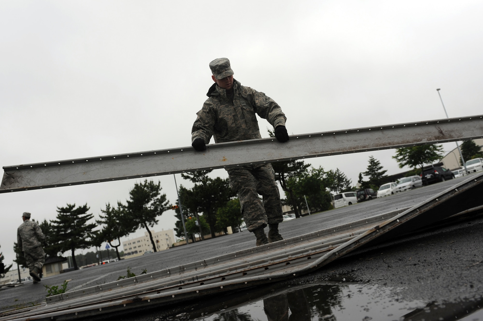 U.S. Air Force Senior Airman Travis Stout, 35th Civil Engineer Squadron structural journeyman, moves scrap metal at Misawa Air Base, Japan, June 27, 2013. The structures Airmen took 34,000 pounds of scrap metal to Defense Logistics Agency Disposition Services.  (U.S. Air Force photo by Airman 1st Class Kia Atkins)
