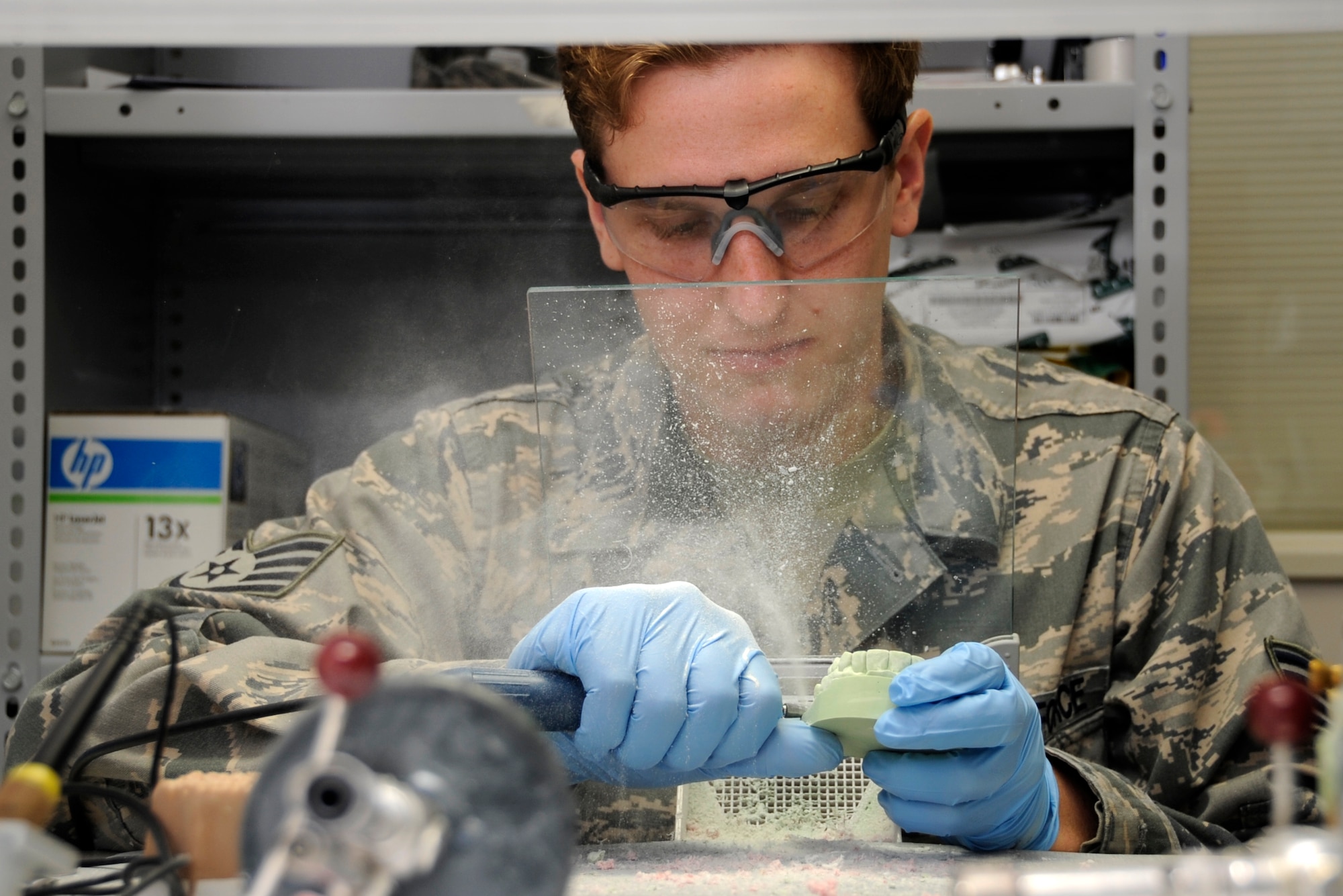 U.S. Air Force Staff Sgt. Cameron Dungey, 35th Dental Squadron dental lab technician, grinds a dental stone impression of a patient's teeth at Misawa Air Base, Japan, June 27, 2013. The dental lab receives approximately 20 impressions each day. Each impression is cast into a mold to use as an accurate base when making crowns and night-guards. (U.S. Air Force photo by Airman 1st Class Kaleb Snay)