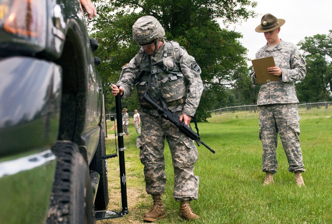 Army Sgt. Jeremiah Rust, right, grades Army Spc. Daniel Lyons during the warrior, task and training portion of the 2013 Army Reserve Best Warrior Competition on Fort McCoy, Wis., June, 25, 2013. Rust is assigned to the 95th Training Division, and Lyons is assigned to the 99th Regional Support Command.
